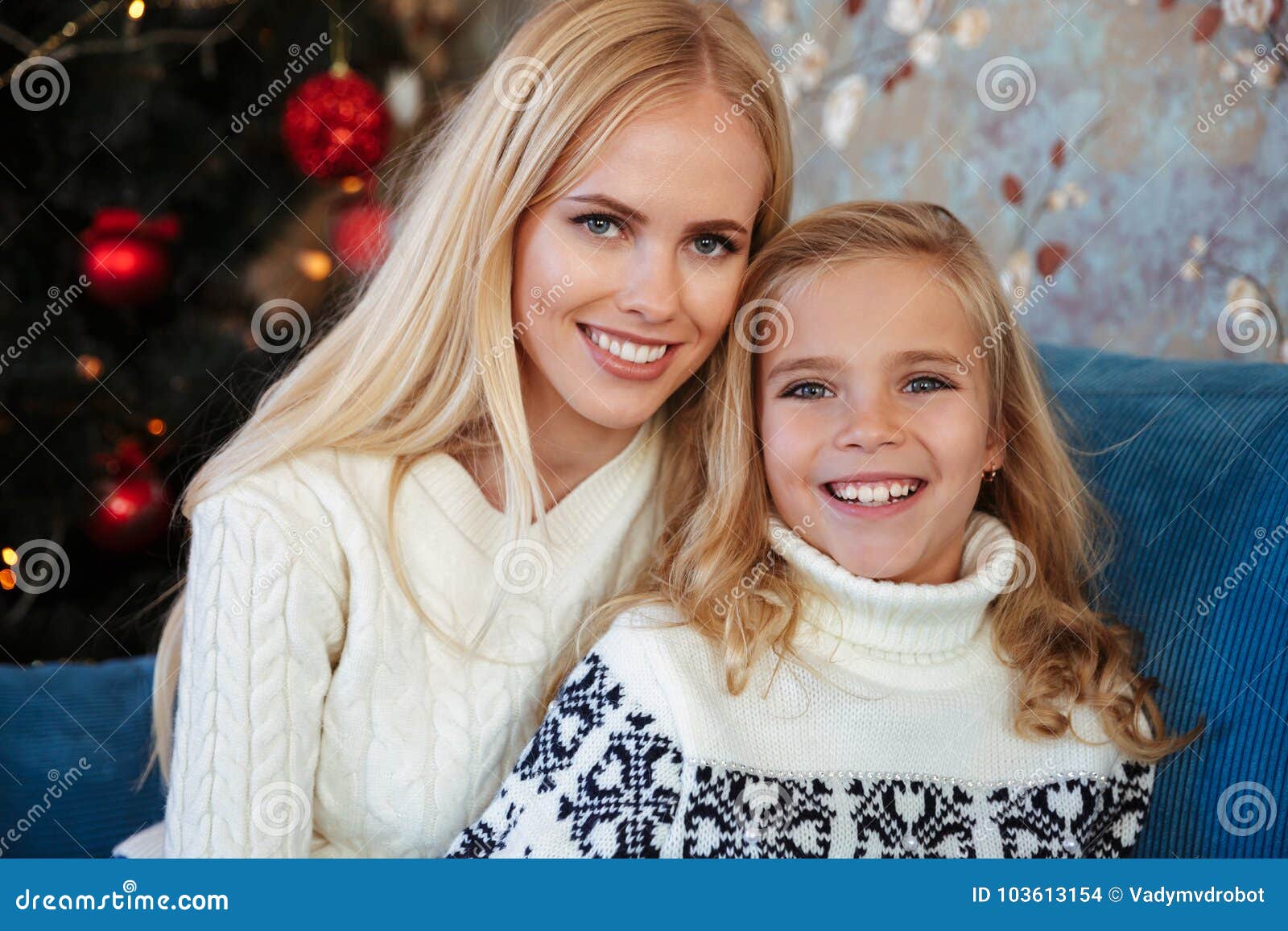 Blonde Mother Smiles And Holds Her Young Child Between Her Arms Royalty