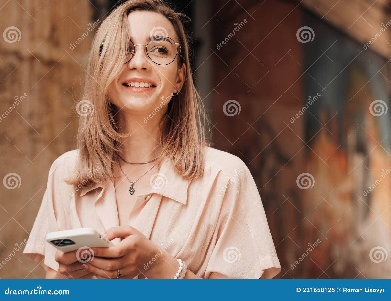 Close Up Portrait Of Cheerful Young Woman With Eyeglasses Texting On Smartphone While Walking In 