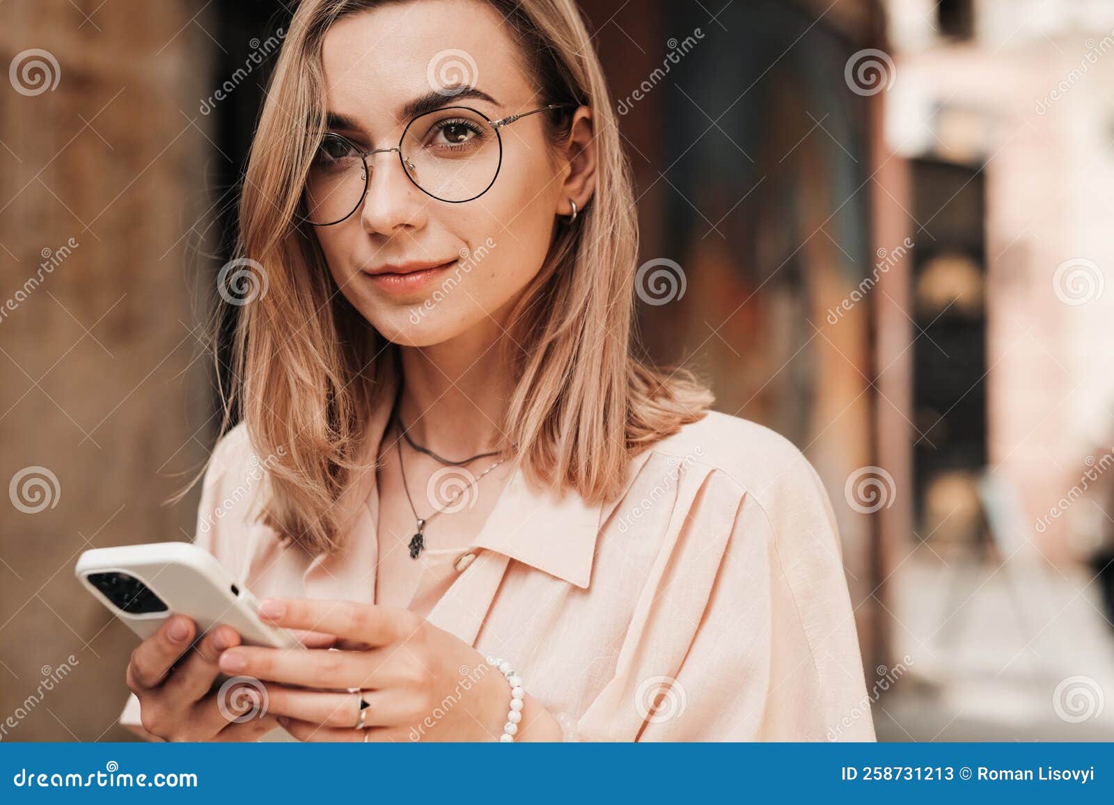 Close Up Portrait Of Confident Young Woman With Eyeglasses Texting On Smartphone While Walking 