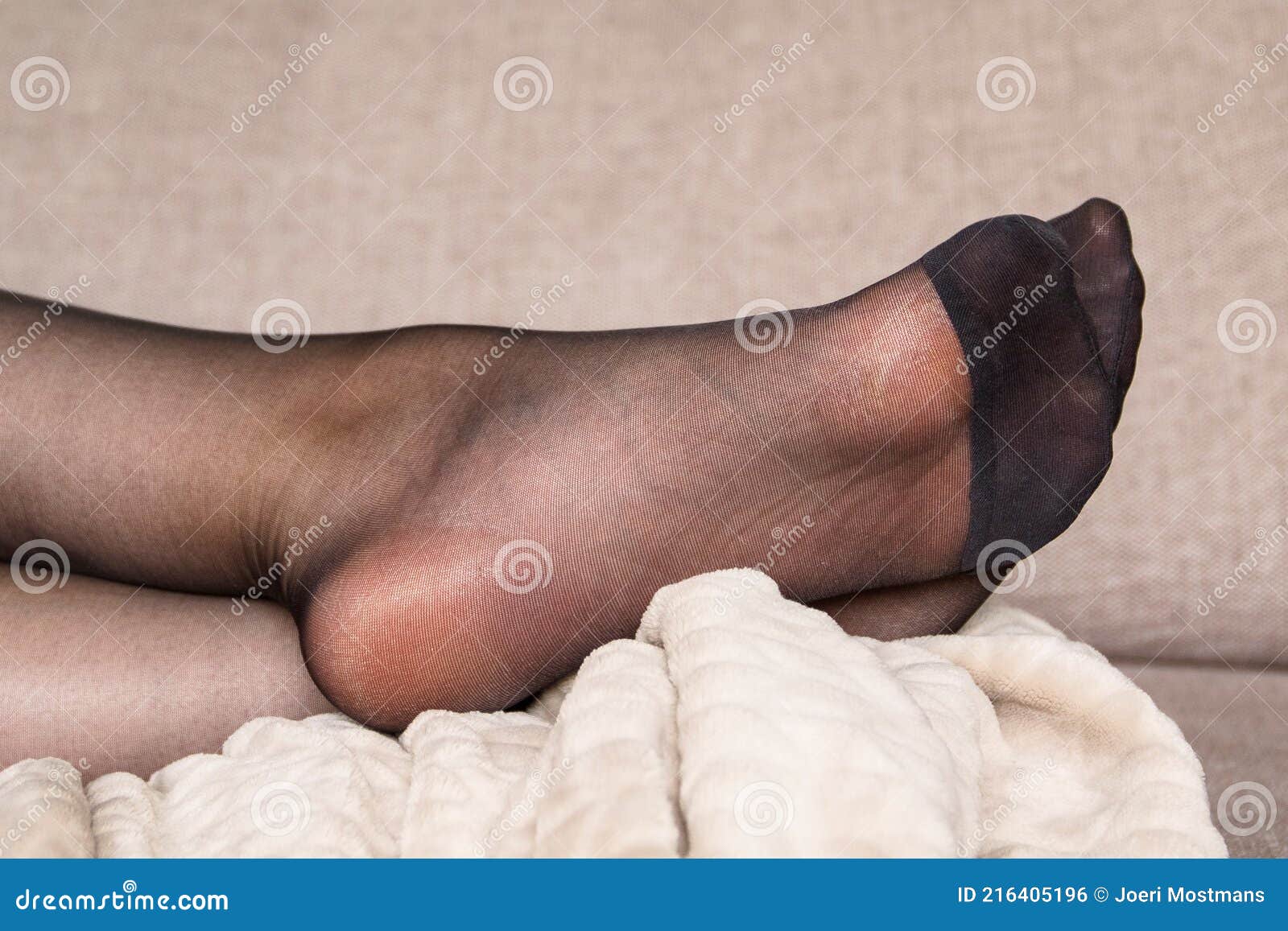 A Close Up Portrait of the Feet of a Woman in Black Nylon Pantyhose or  Stockings Lying on a Couch in a Living Room with Her Legs Stock Photo -  Image of