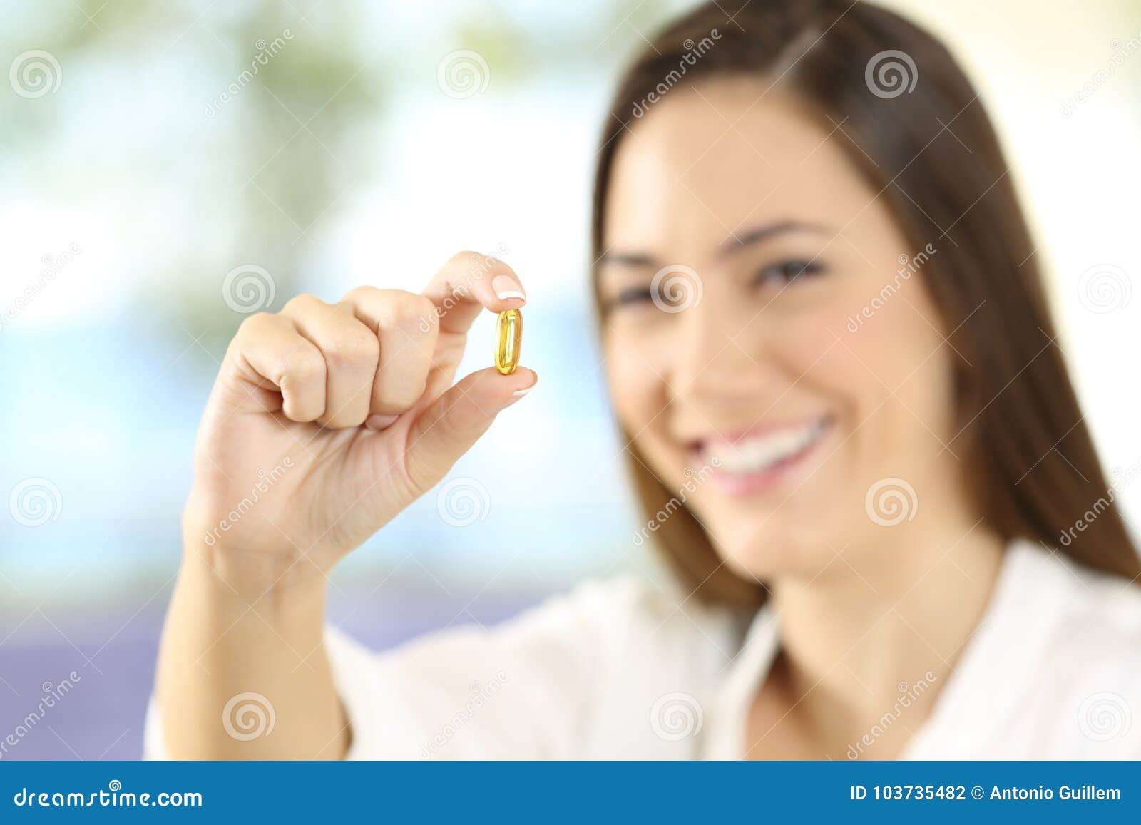 Happy Woman Showing An Omega 3 Pill Stock Photo - Image of ...