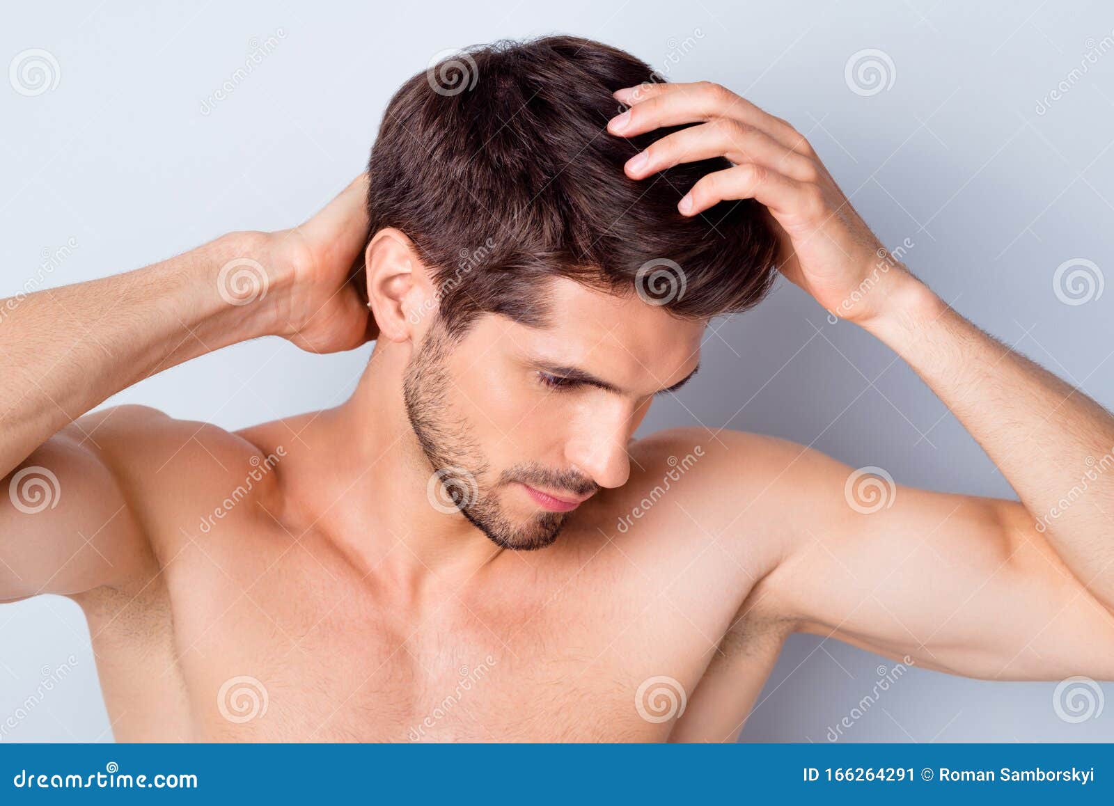 close-up portrait of his he nice attractive stylish brown-haired guy touching smooth healthy shine hair anti dander
