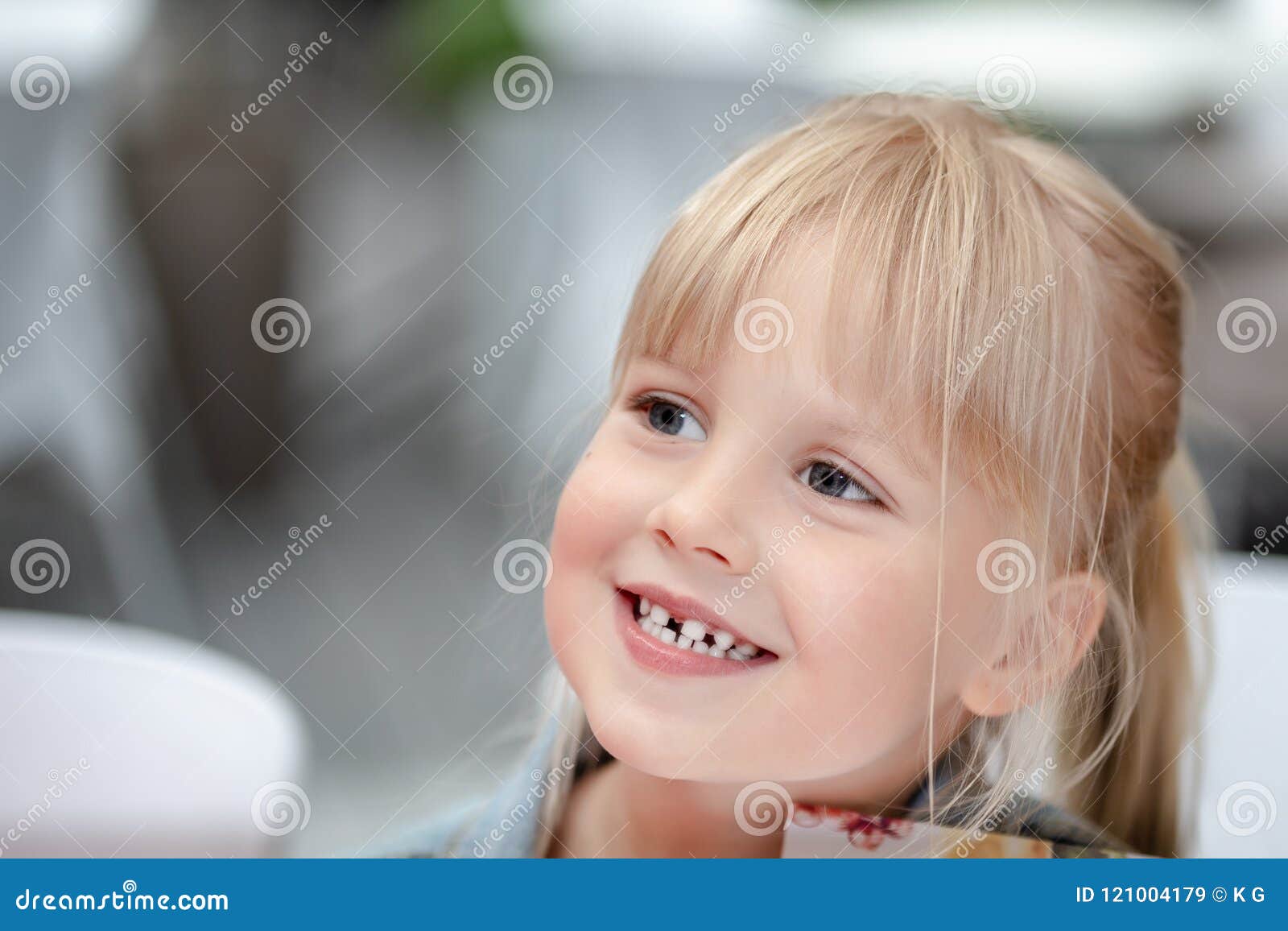 Close Up Portrait Of Little Cute Blond Caucasian Girl In