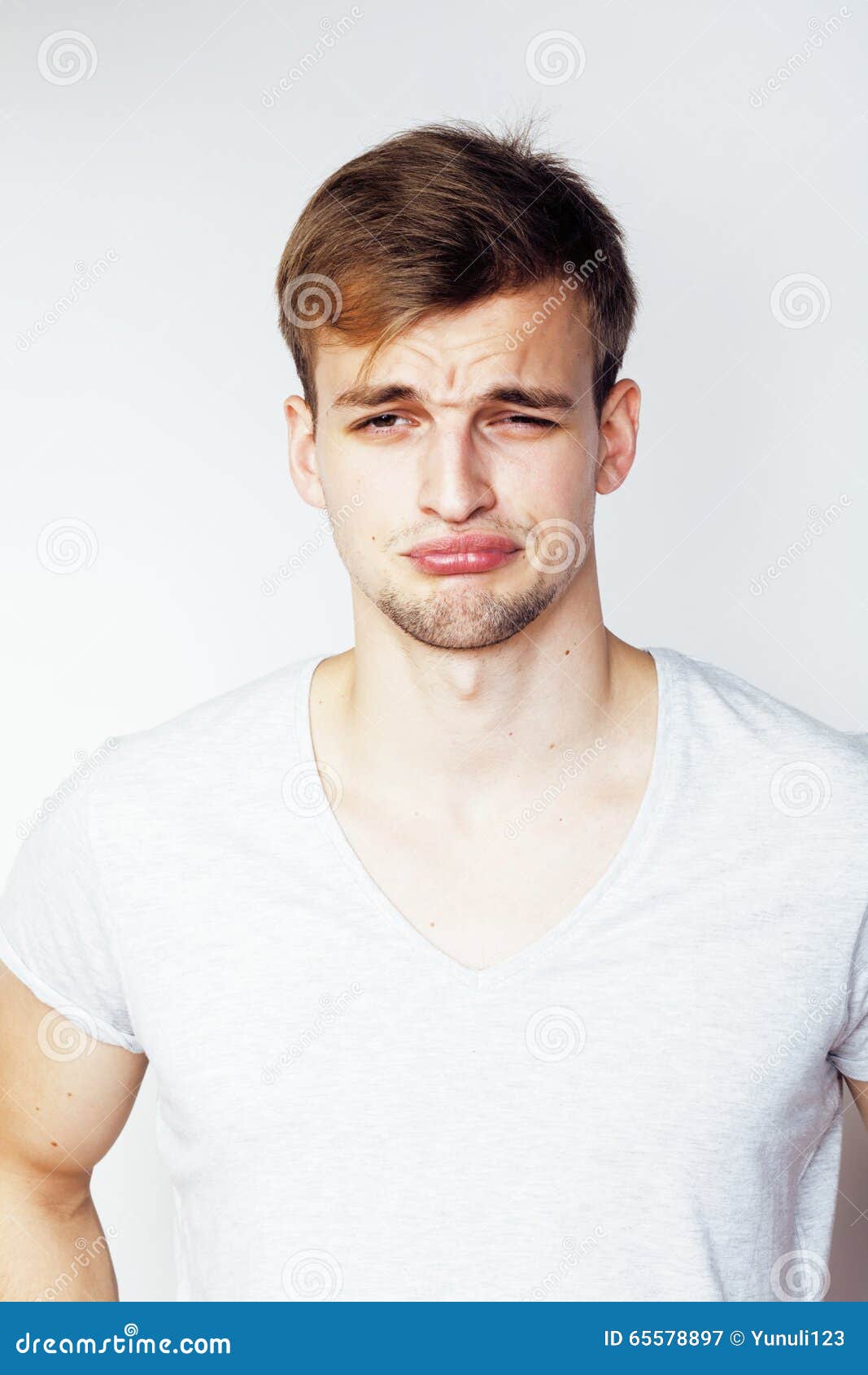 close up portrait of loudly laughing young man  on white background