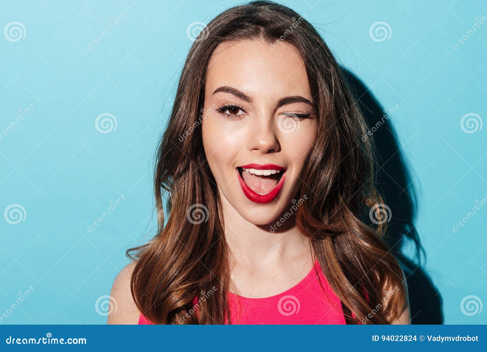 close up portrait of a pretty young woman winking