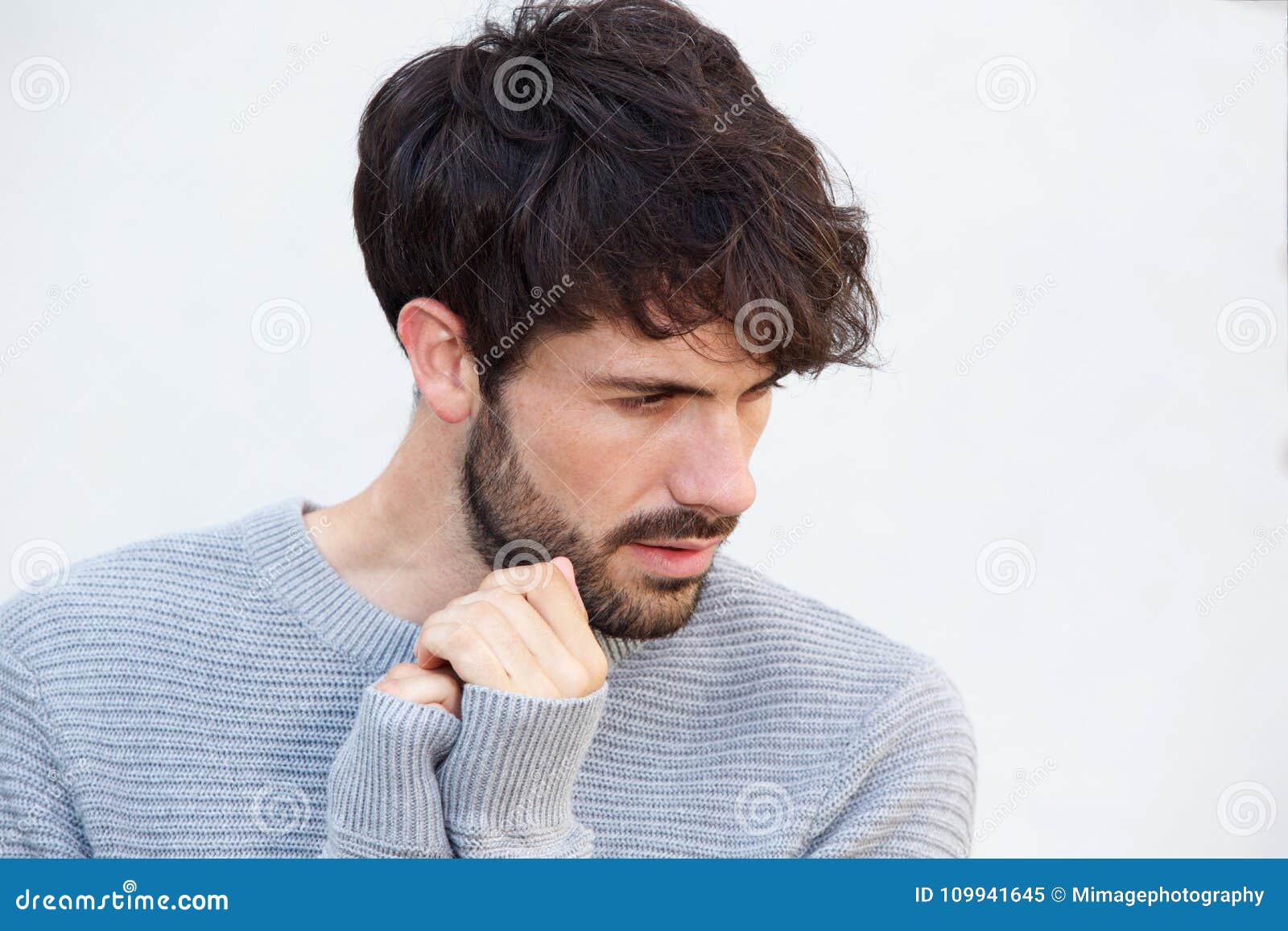 Profile view of sad young man looking down Stock Photo - Alamy