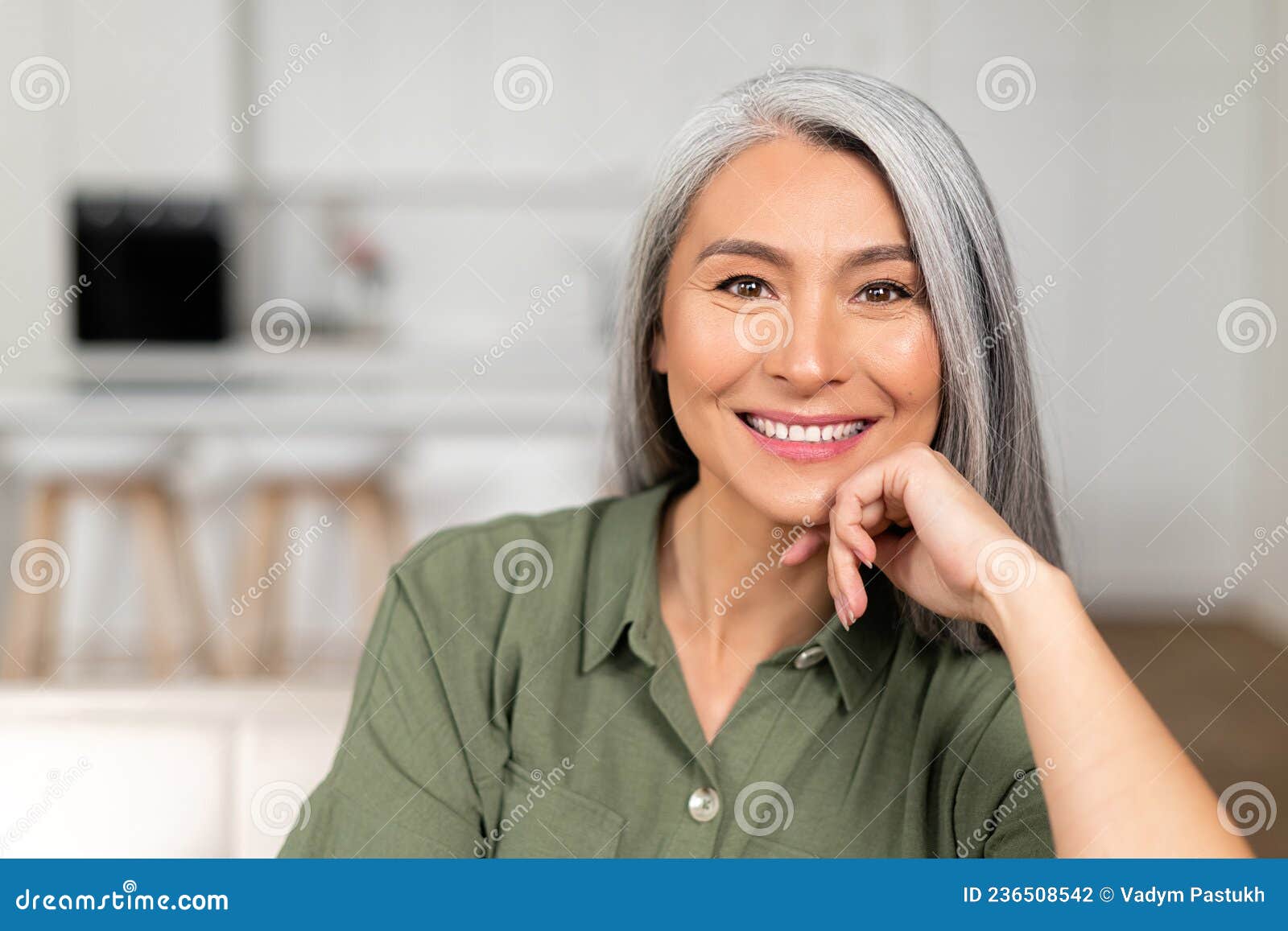 close-up portrait on senior gray-haired woman in home interior