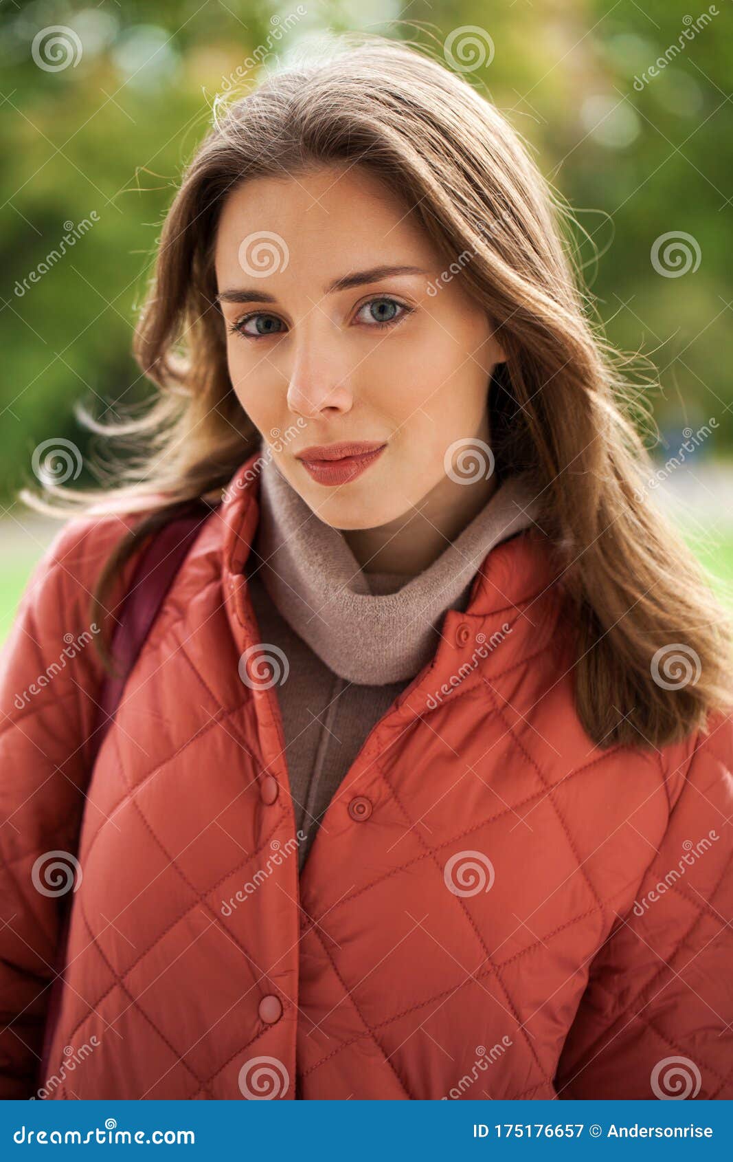 Close Up Portrait Of A Young Beautiful Brunette Girl In Coral Coat 