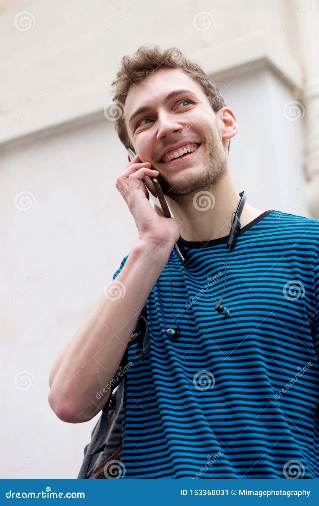 Close Up Young Man Smiling And Talking With Mobile Phone
