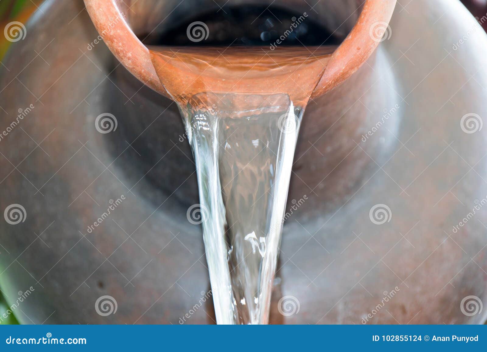 close up pour water out of terracotta pots.