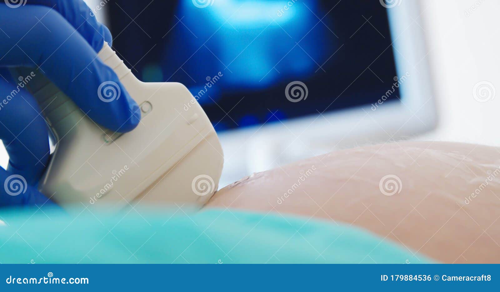 close up of a pregnant woman having ultrasound scanning at the medical clinic. family planning concept