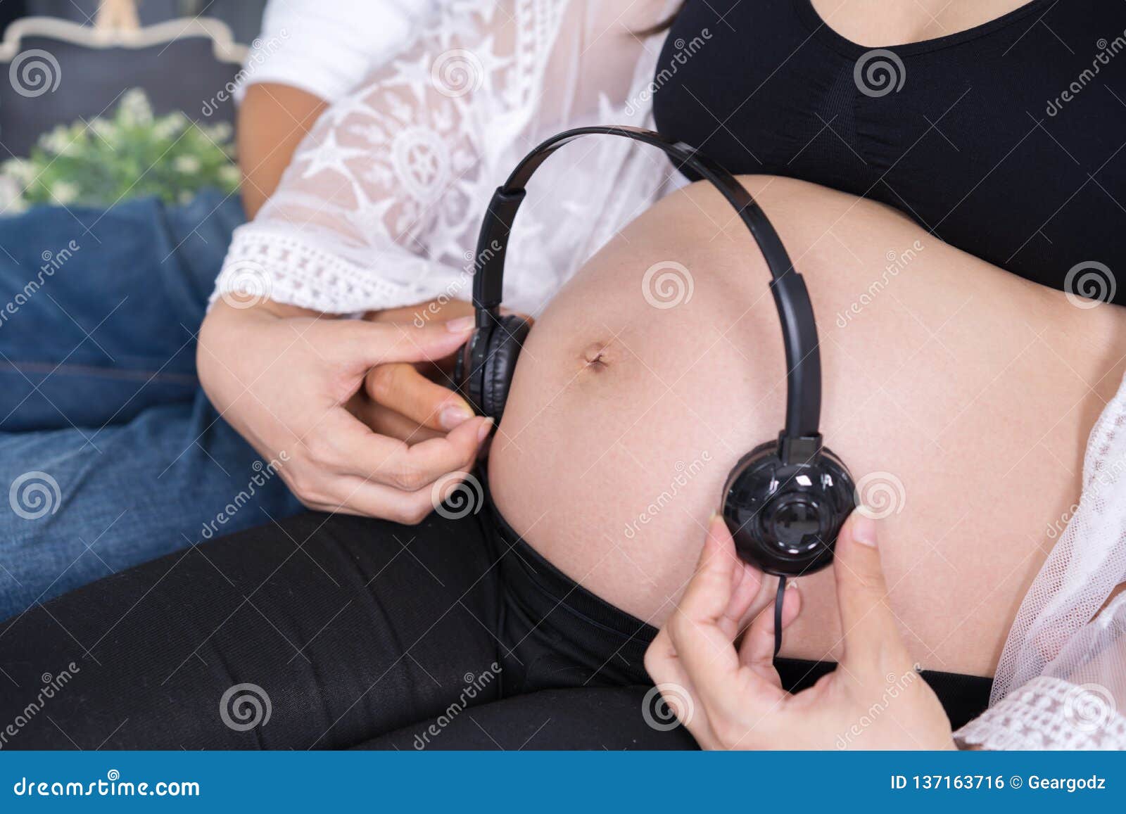 Pregnant Woman Playing Music To Her Baby With Headphones On Belly Stock  Photo, Picture and Royalty Free Image. Image 116985232.