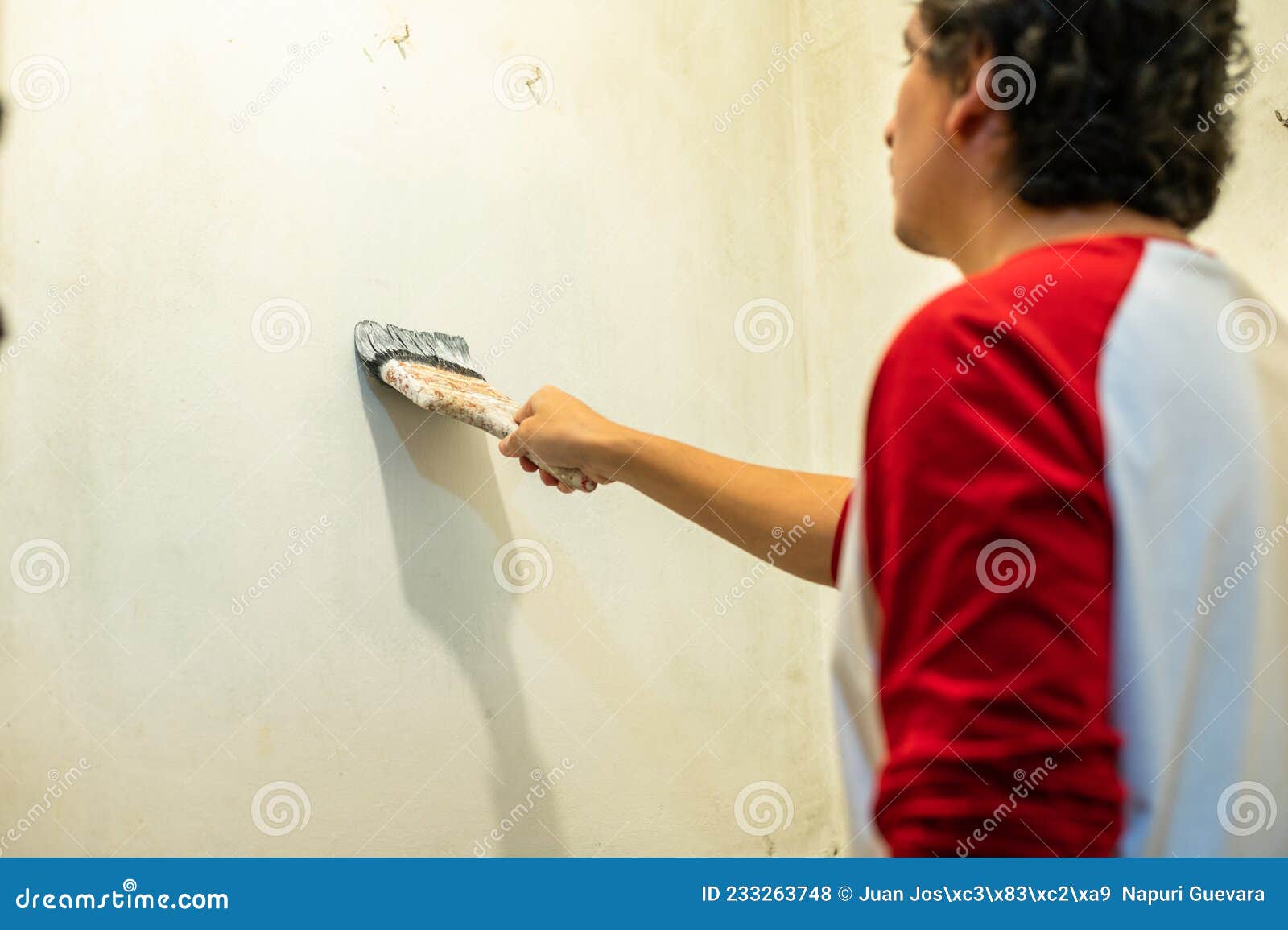 Closeup of Professional House Painter Painting a White Wall. Stock Photo Image of occupation