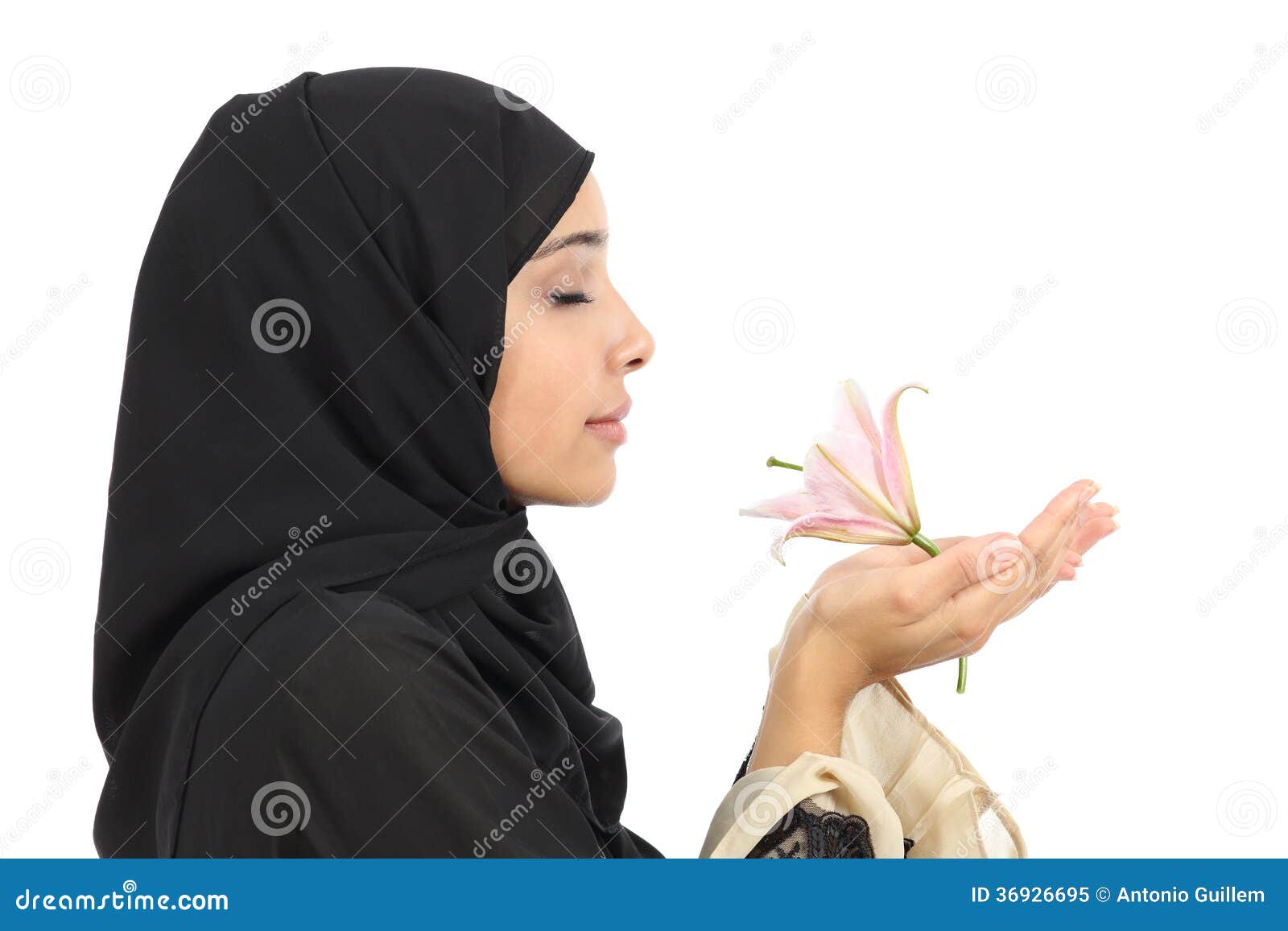 Close Up Of A Profile Of An Arab Woman Smelling A Flower 