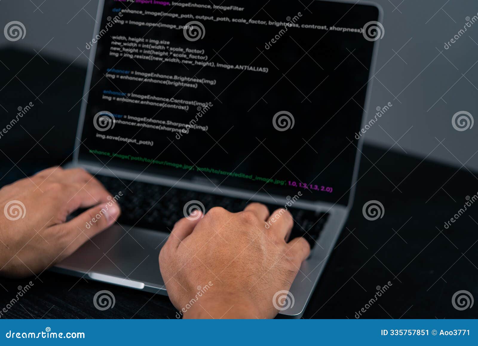 close-up of a programmer's hands coding on a laptop. highlights the software development process and coding environment.