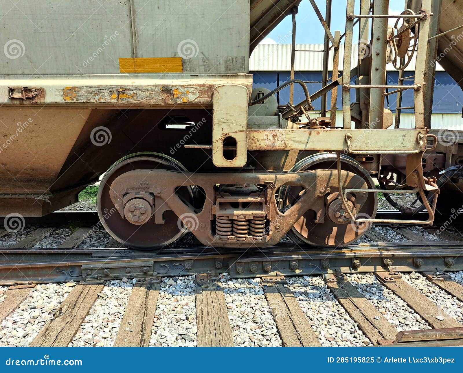 close-up of railway wheels on rails, which support high loads rigidly coupled to the same axle, forming sets of wheels