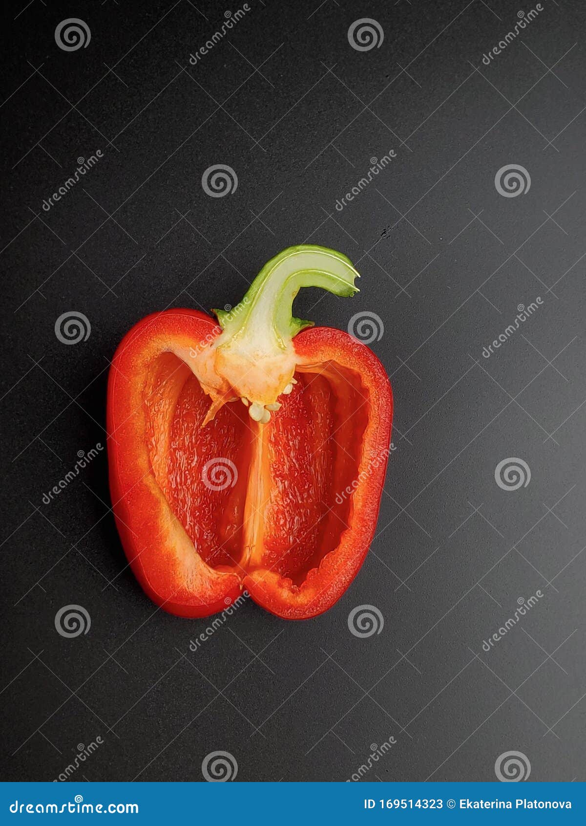 Closeup of Red Bell Pepper, Cut in Half, Inside with Seeds, Isolated on a Black Background
