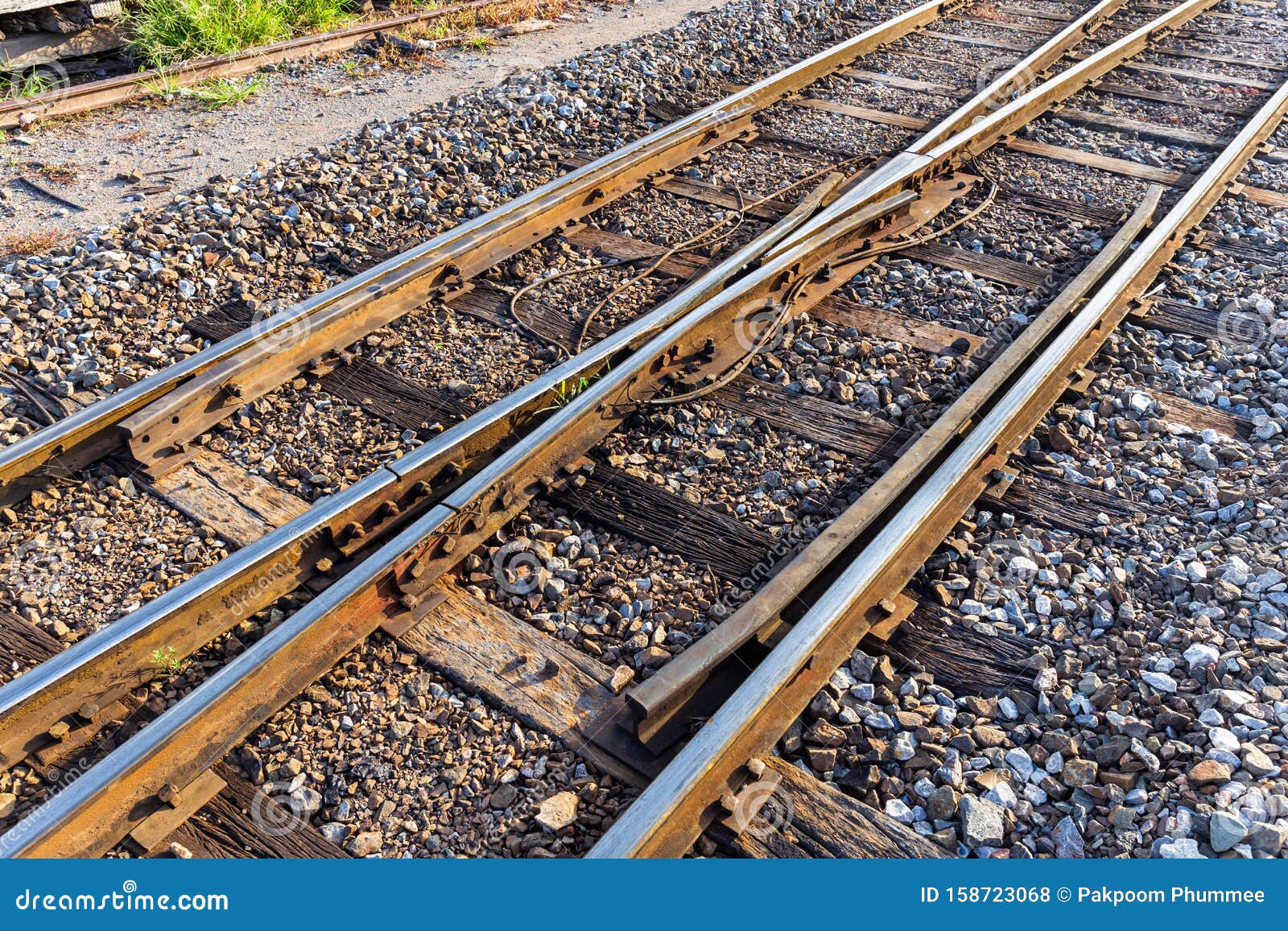 close up of redirection old train or railroad tracks with wooden backing in the countryside