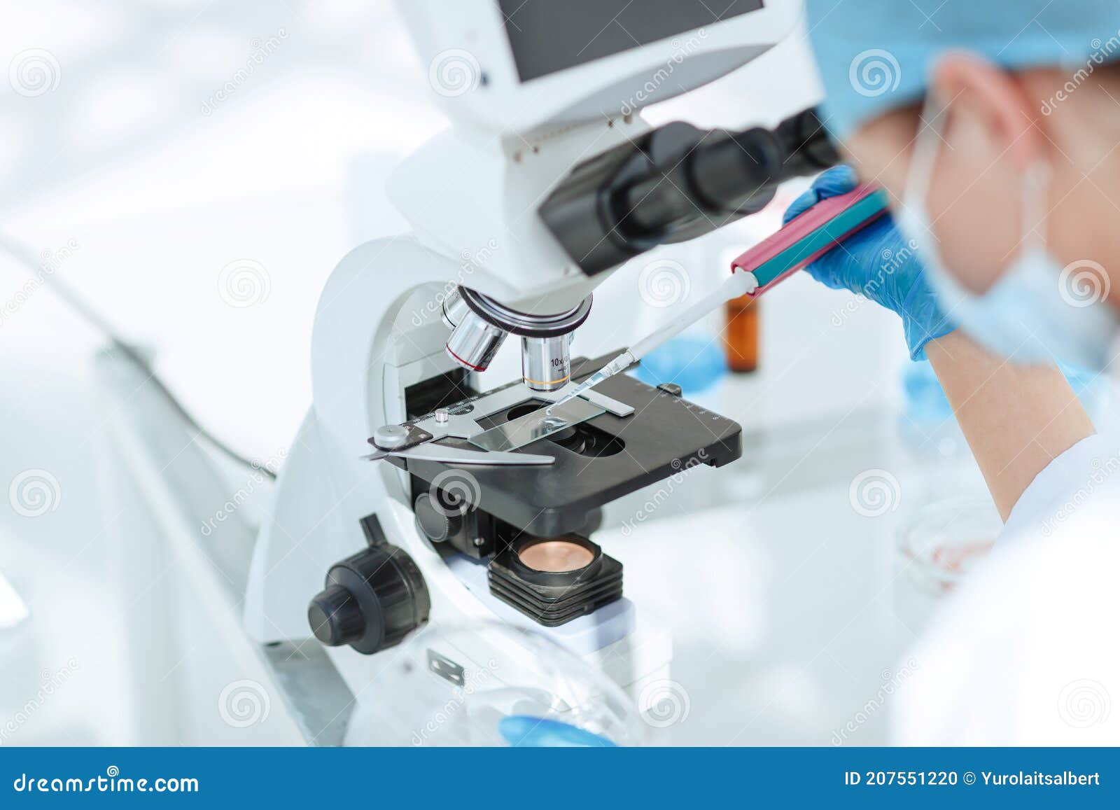 Close Up. Researcher Testing the Blood Under a Microscope Stock Photo