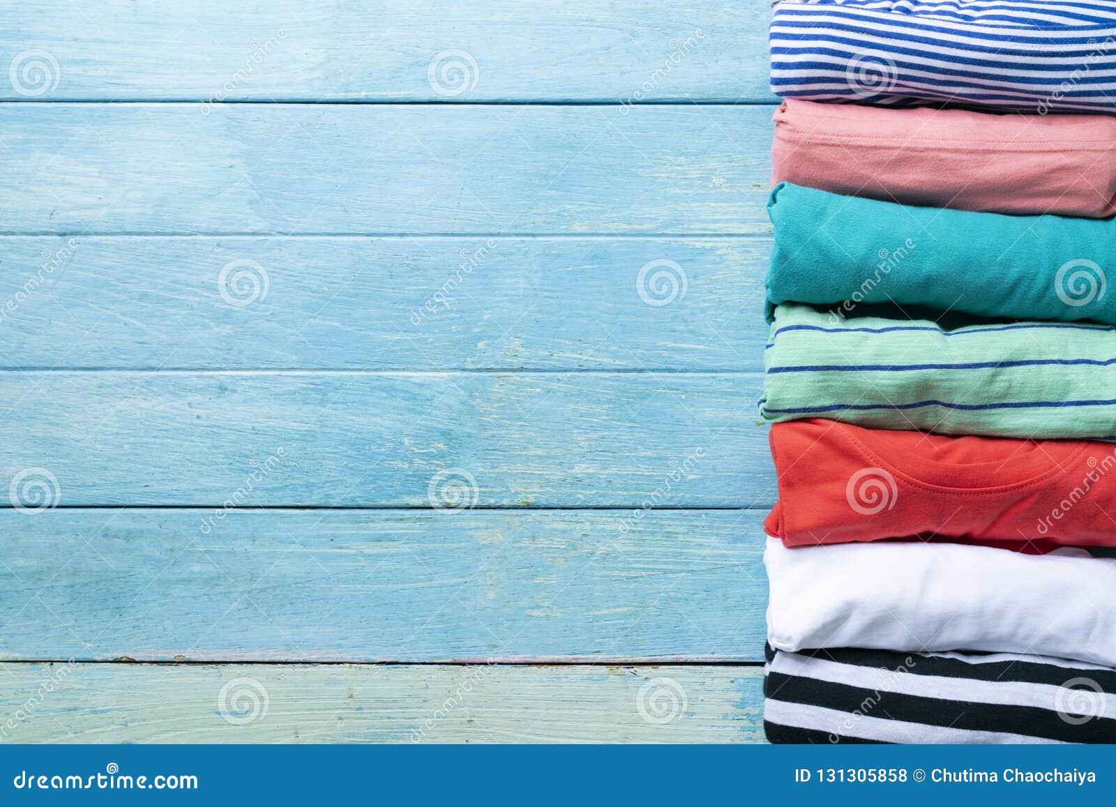 Close Up of Rolled Colorful Clothes on Blue Background Stock Photo - Image  of basket, casual: 131305858