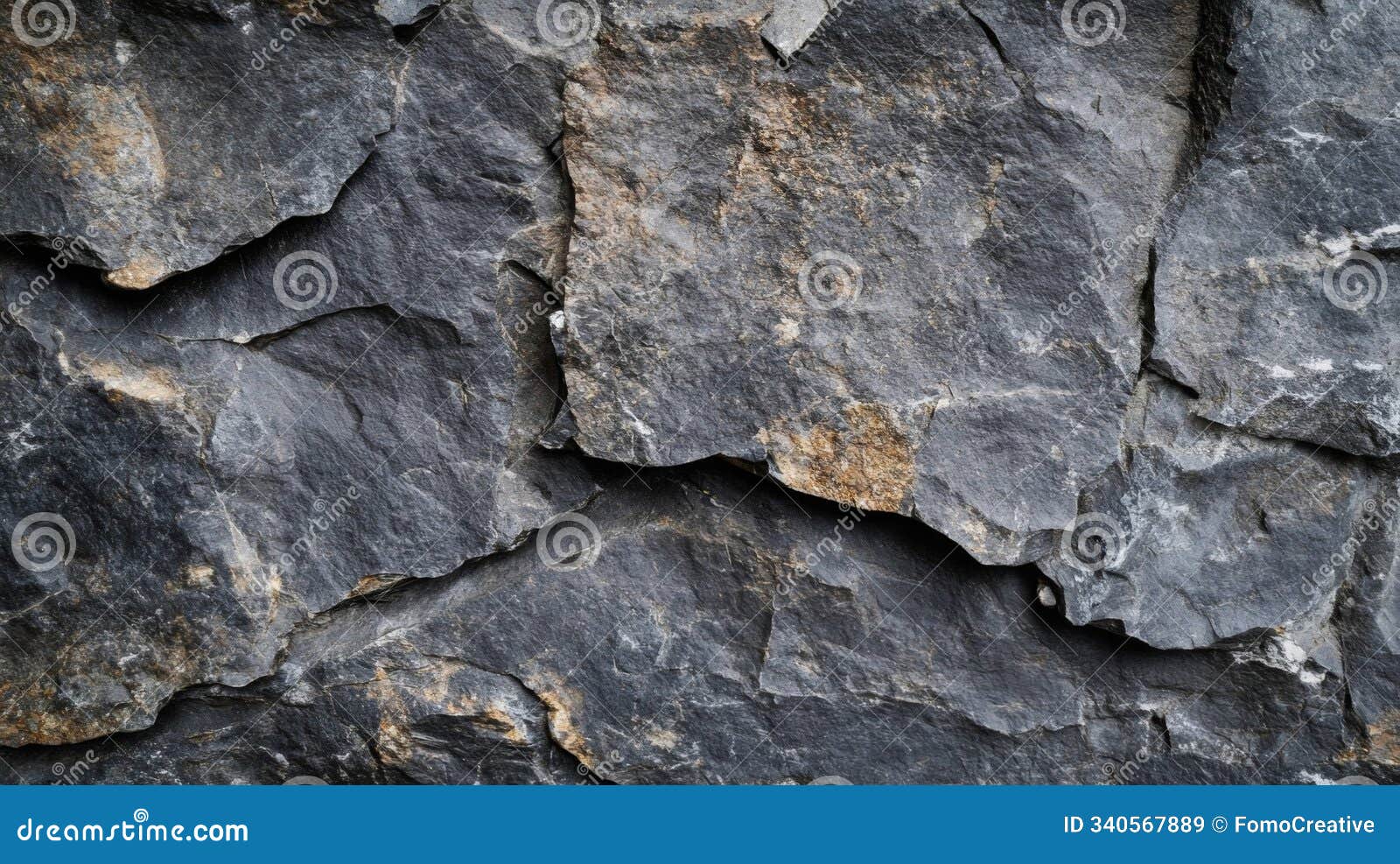 close-up of rough, gray stone texture with a slight golden tint