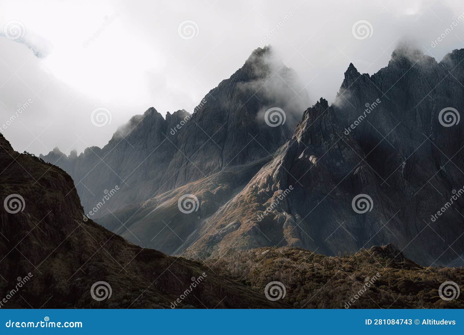 Closeup of Rugged Mountain Range, with Wind and Clouds Sweeping the Peaks Stock Image Image
