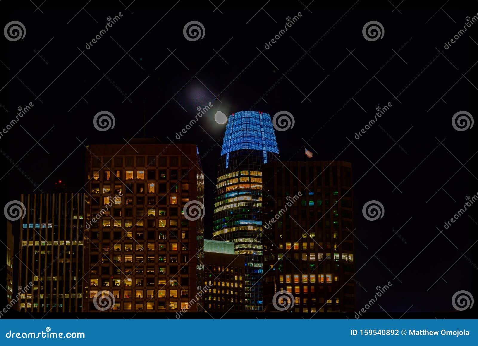 close up of salesforce tower san francisco with moon, night time