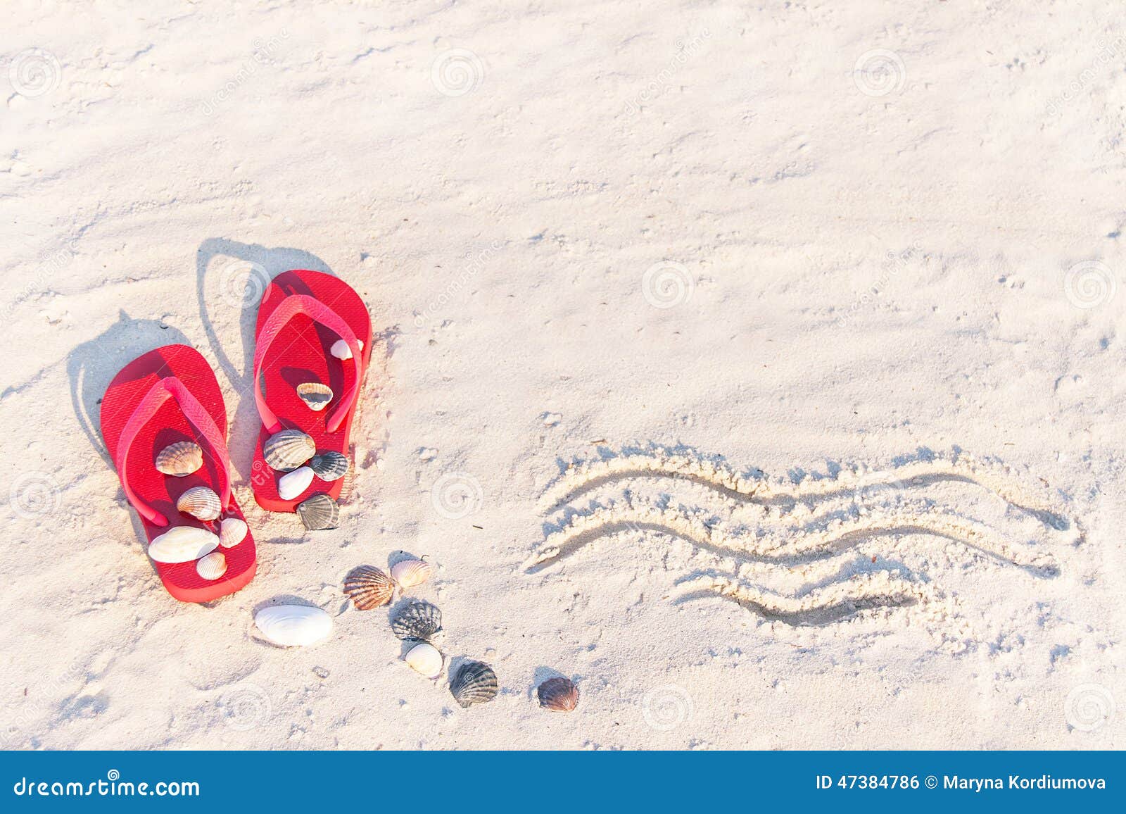 close up of sand texture with flip flop sandals and shellfishes.