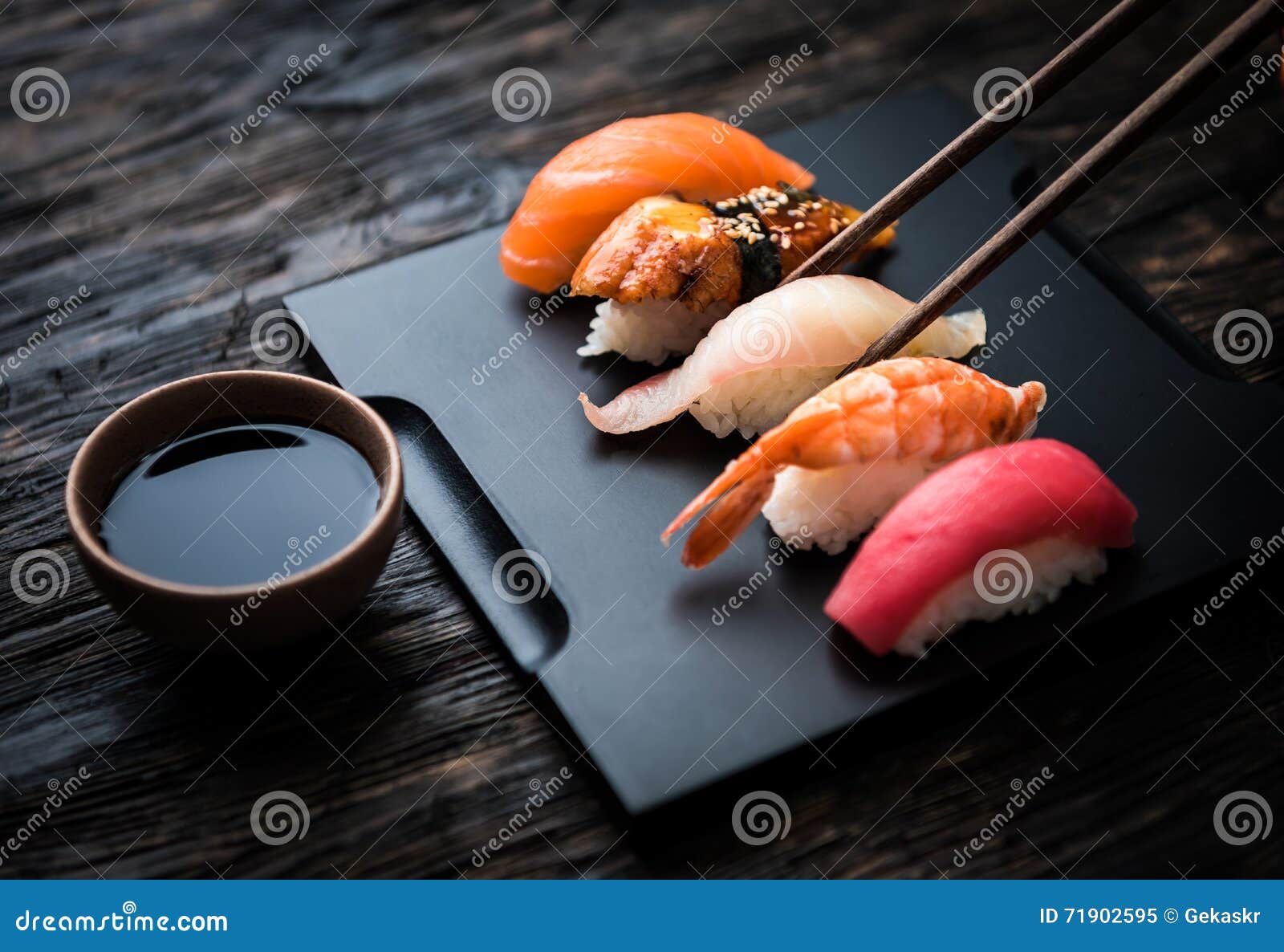 close up of sashimi sushi set with chopsticks and soy