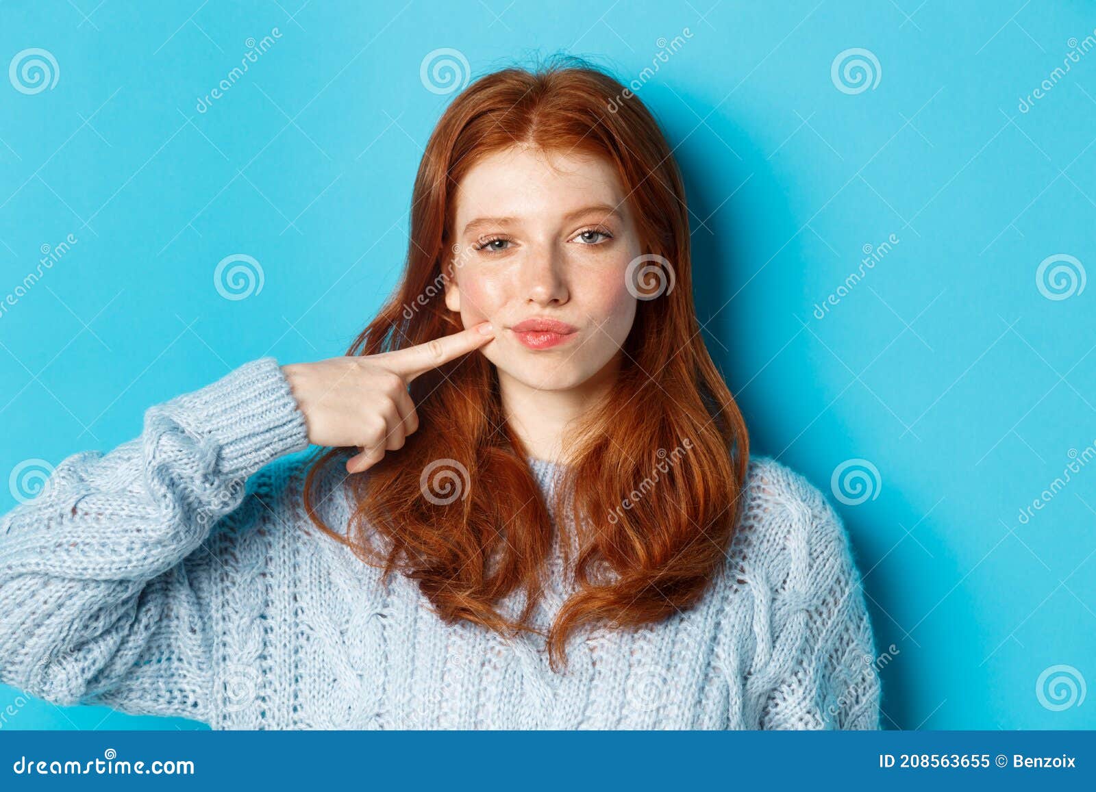 Close-up of Sassy Teen Girl with Red Hair, Pointing at Her Cheek and ...