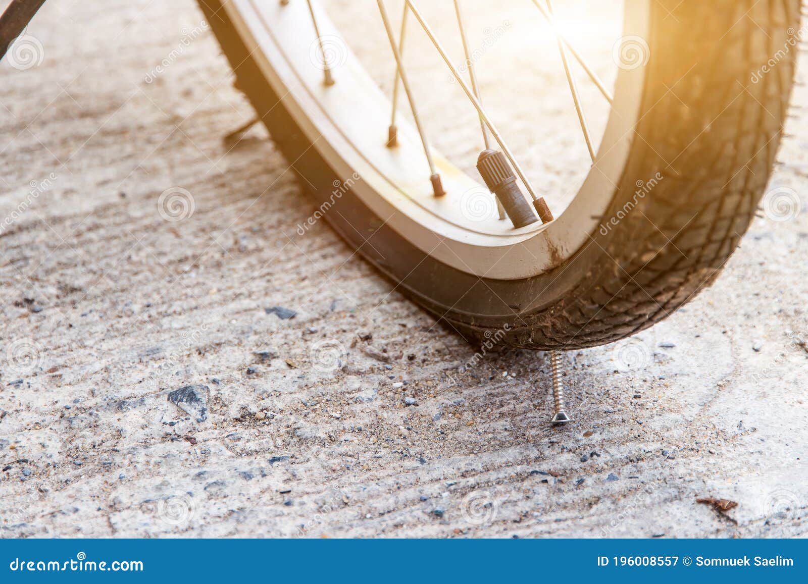 Close Up of Nail Puncturing Motorcycle Tire or Bicycle Tire Stock Image