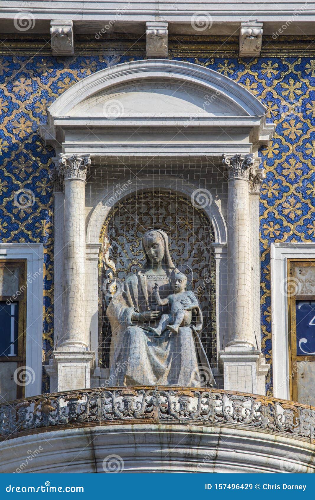 sculpture of virgin and child on st. marys clock tower in venice