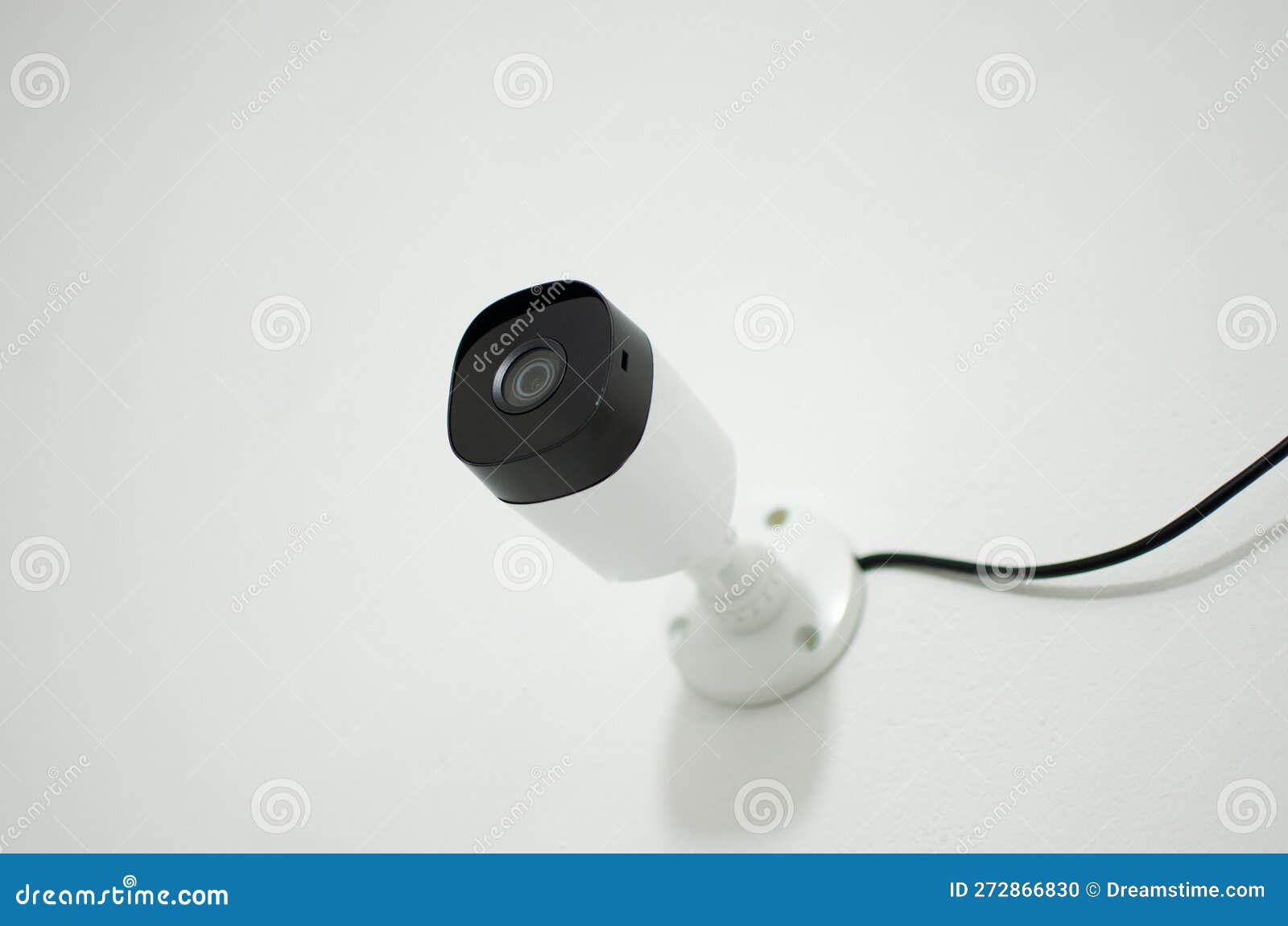 Closeup of a Security Camera Mounted on a Wall in a Modern Office, Ready To Be Used Stock Photo