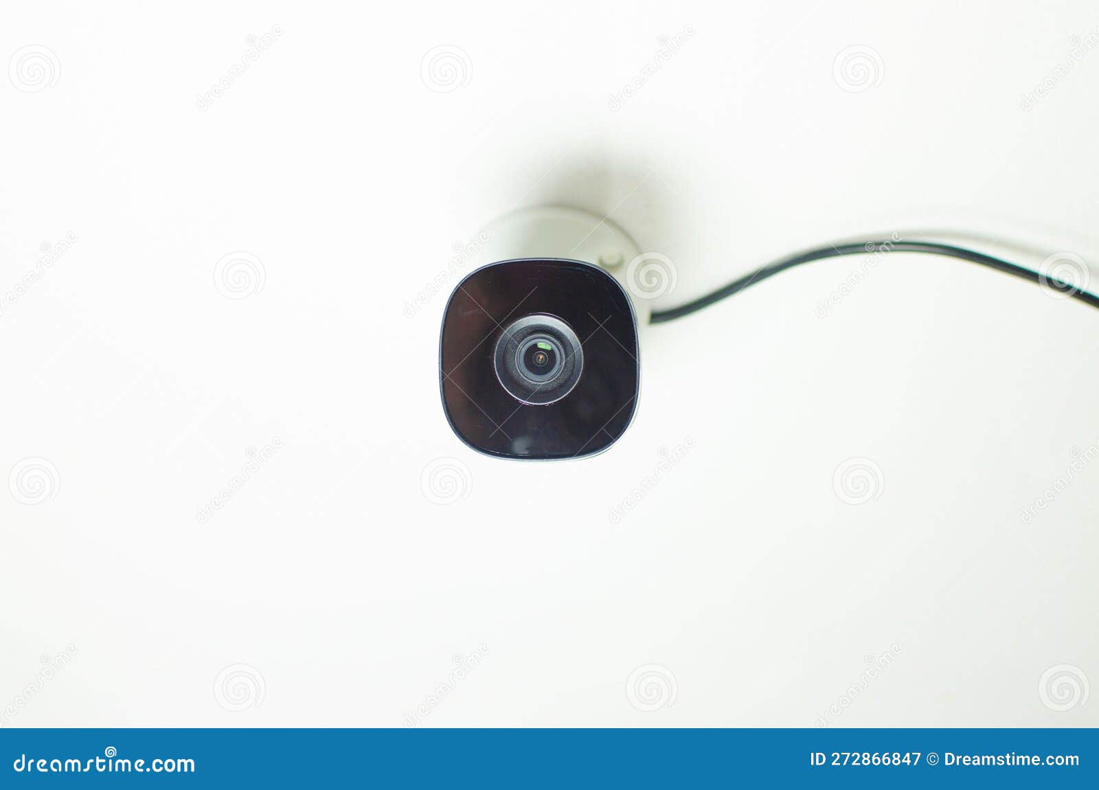Closeup of a Security Camera Mounted on a Wall in a Modern Office