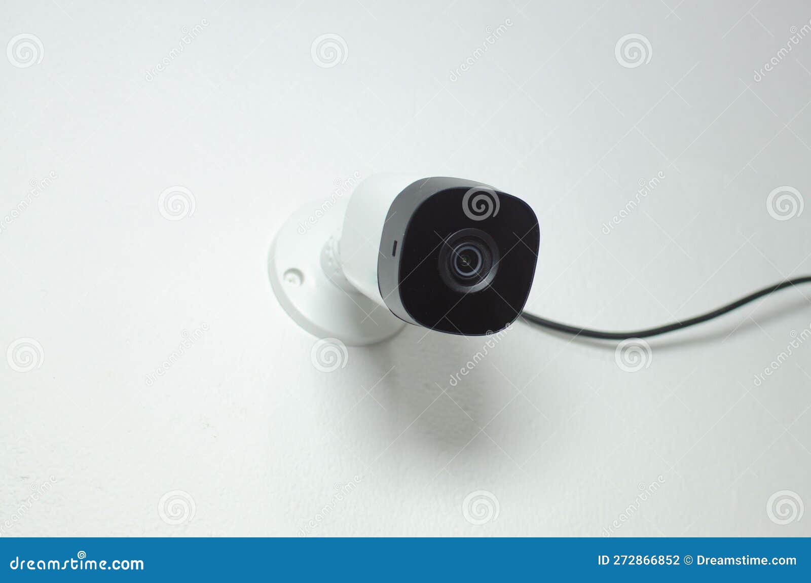 Closeup of a Security Camera Mounted on a Wall in a Modern Office, Ready To Be Used Stock Photo