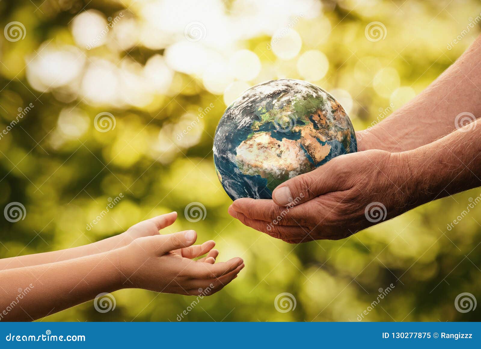 senior hands giving planet earth to a child