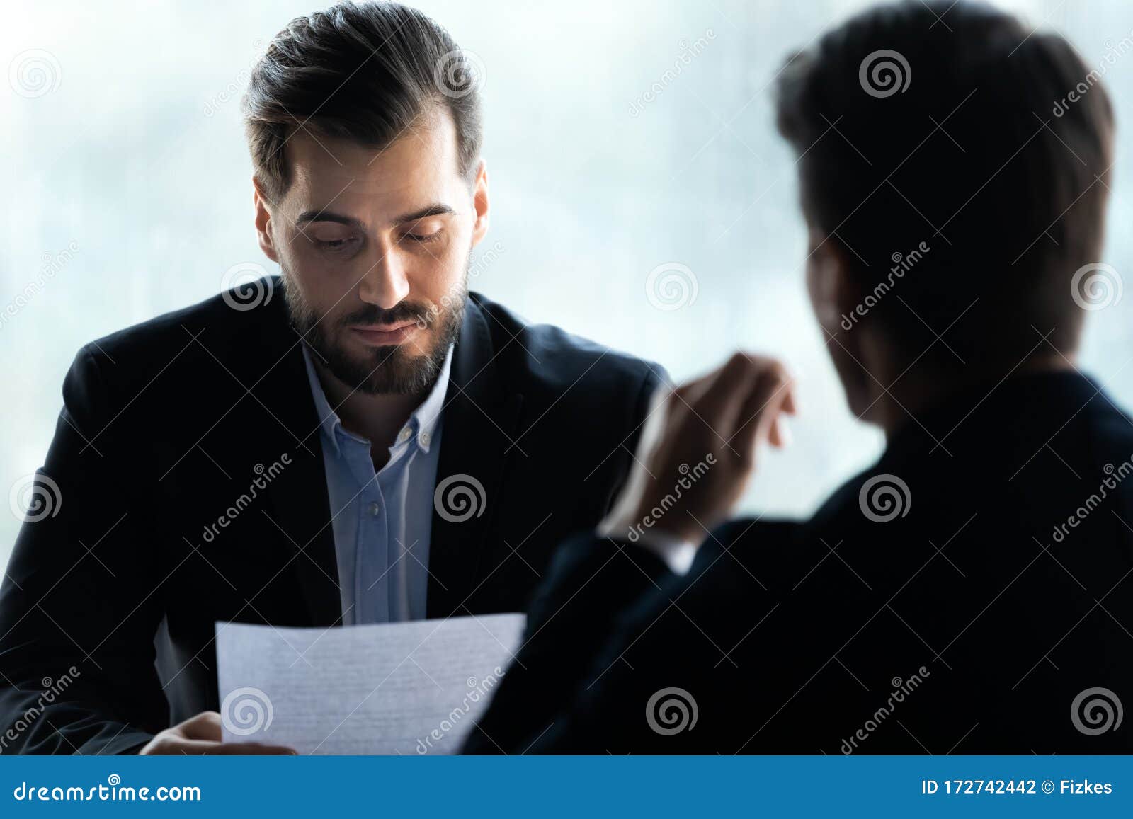 close up serious businessman reading cv new job candidate.