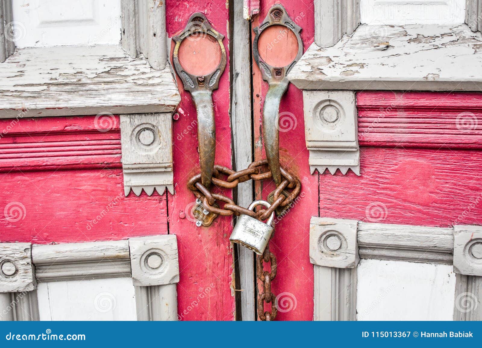 abandoned red church doors with chain and lock