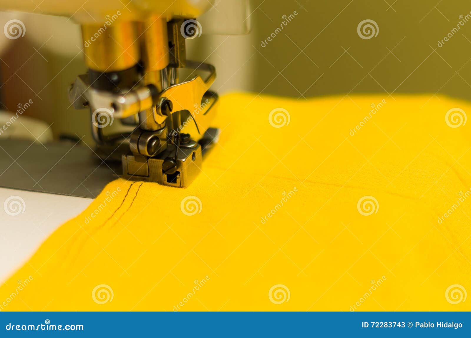 Close Up of Sewing Machine Making Double Stitch with Black Thread on Yellow Fabric Stock Image