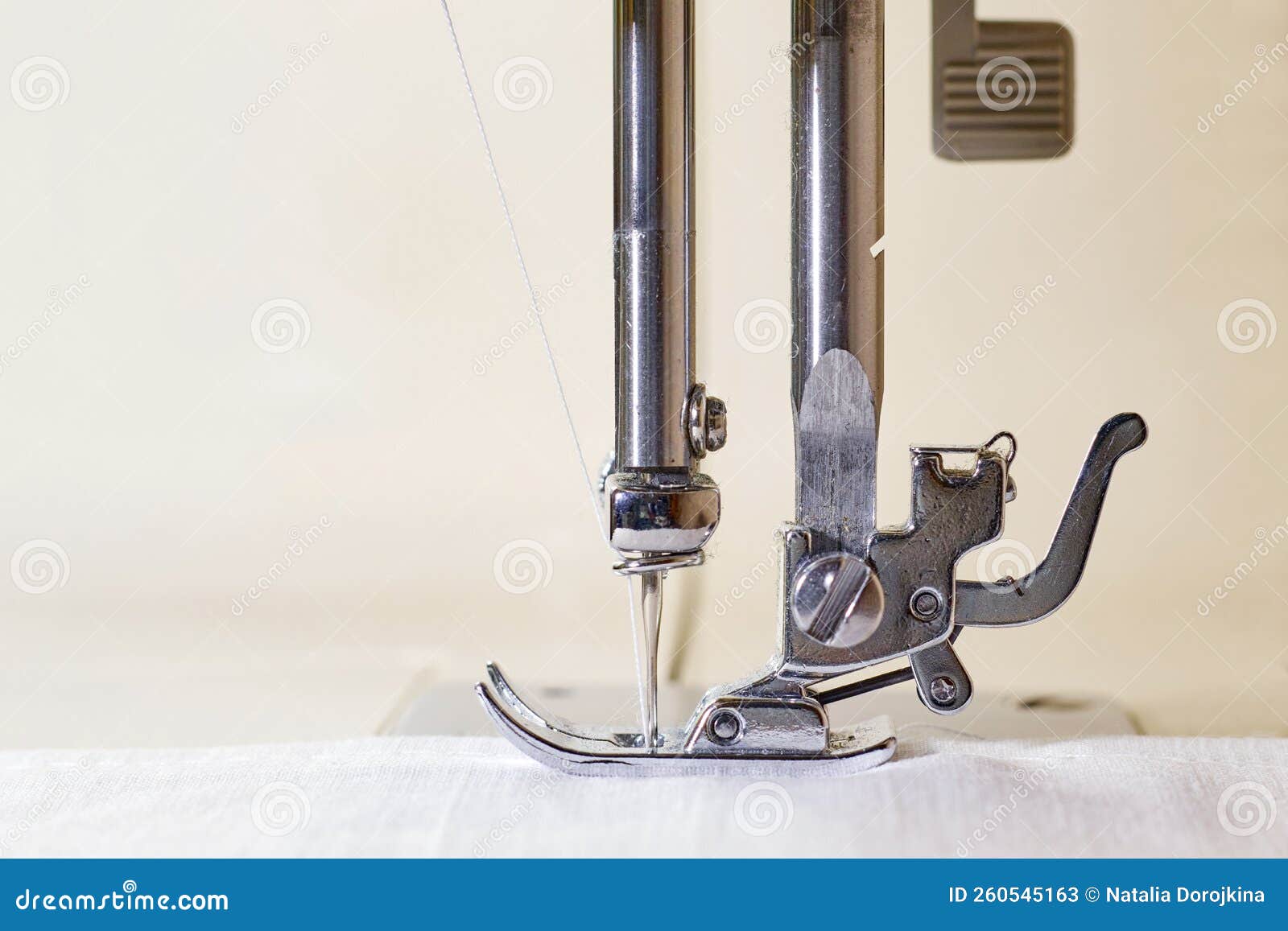 Closeup of a Sewing Machine and a Sewing Needle. Foot and Needle of a