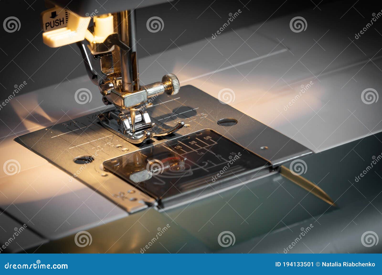 Closeup of a Sewing Machine and a Sewing Needle in the Light of an