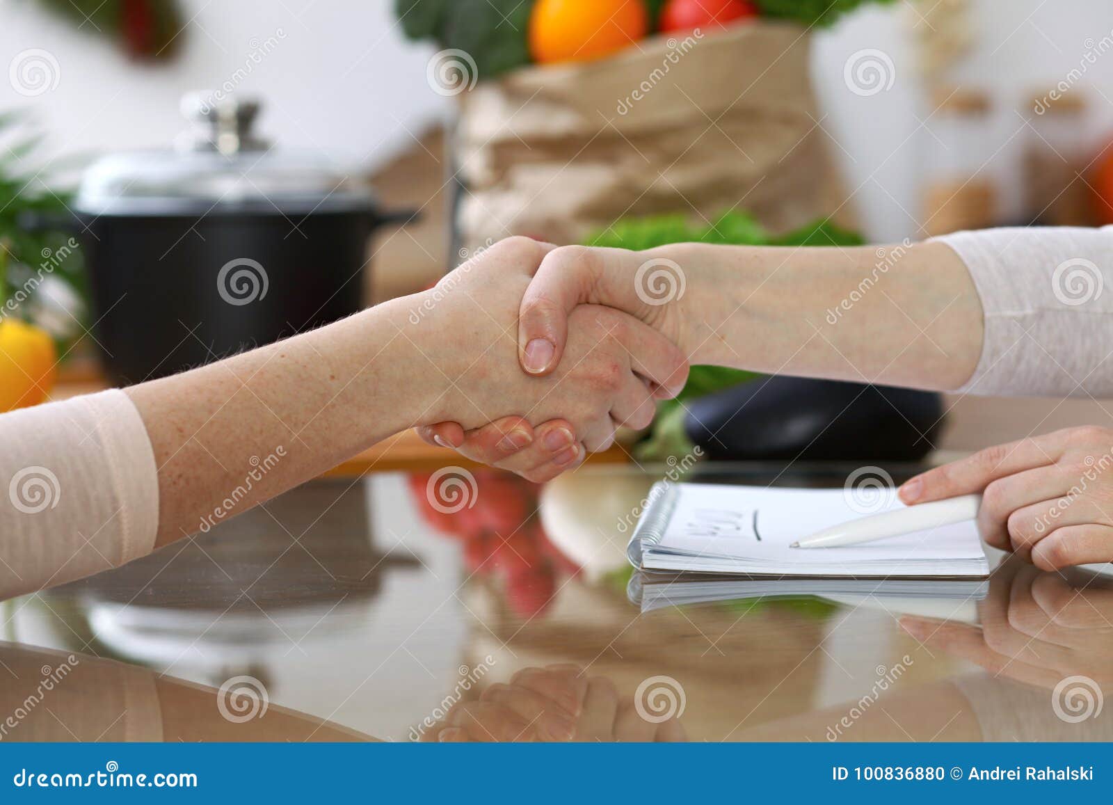 Close-up Of Shaking Hands Over A Table In The Kitchen ...