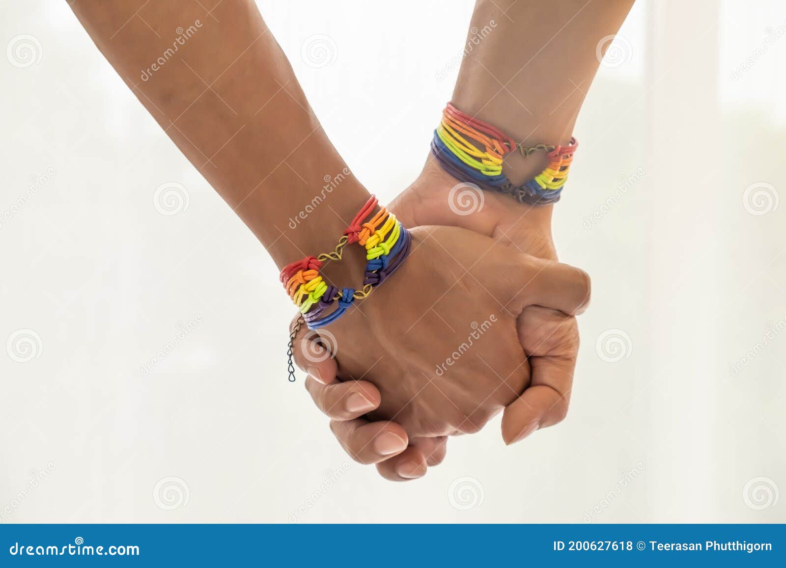 Close Up Shot of Asian Male Couple Holding Hands with Gay Pride Rainbow Awareness Wristbands picture