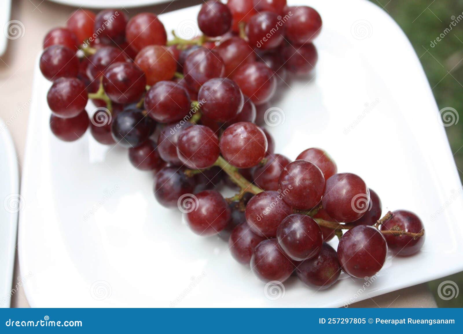 Closeup Shot of the Chinese Grapes on the White Ceramic Plate. Stock