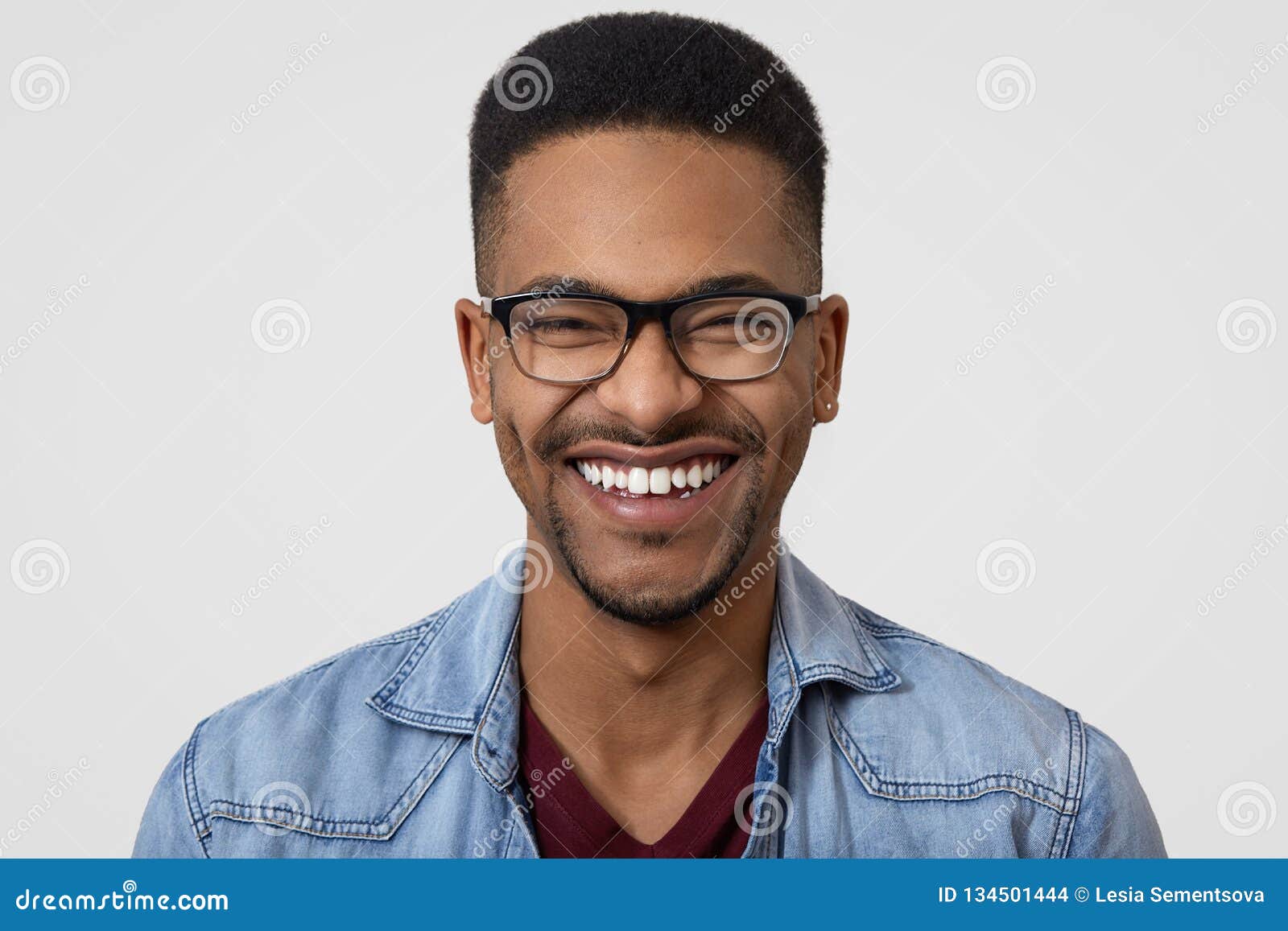 Close Up Shot of Dark Skinned Guy with Broad Toothy Smile, White Teeth,  Wears Denim Shirt, Spectacles, Has Short Curly Hair, Stock Photo - Image of  confidence, closeup: 134501444