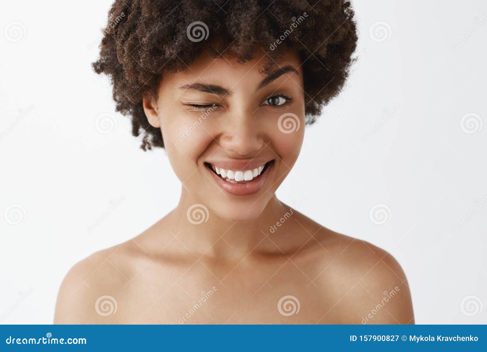 Close Up Shot Of Emotive Happy And Friendly Looking Attractive Dark Skinned Model With Afro