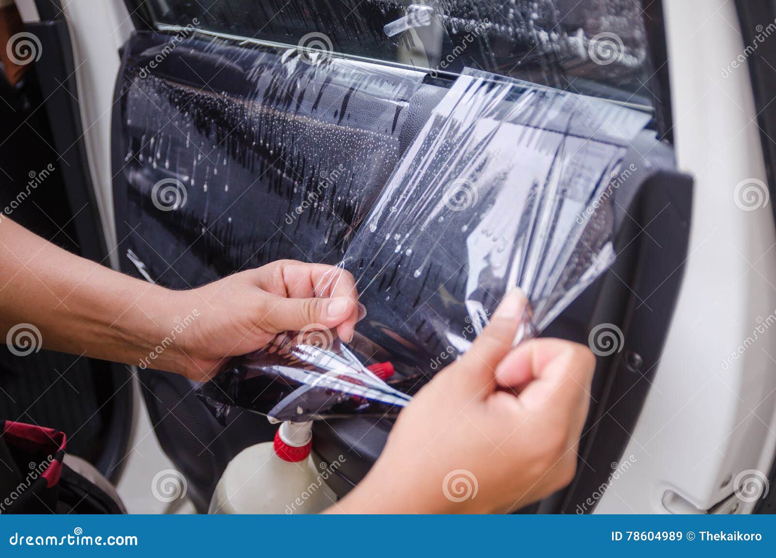 Close-up Of Man's Hand Cleaning The Car Window By Squeegee Stock