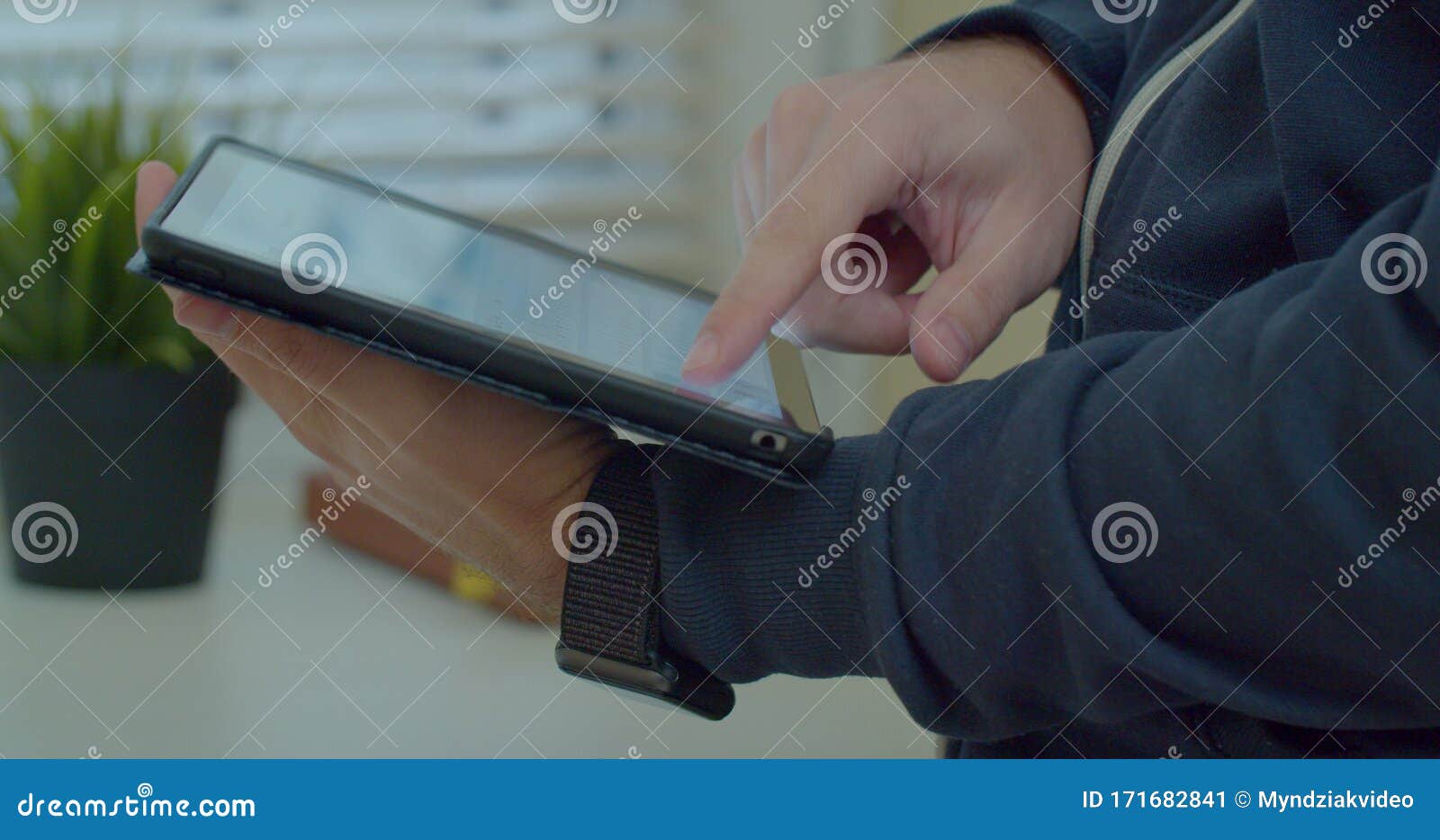 close-up shot of male hands in profile typing in messenger using tabletpc. hands typing text on tabletpc close-up.