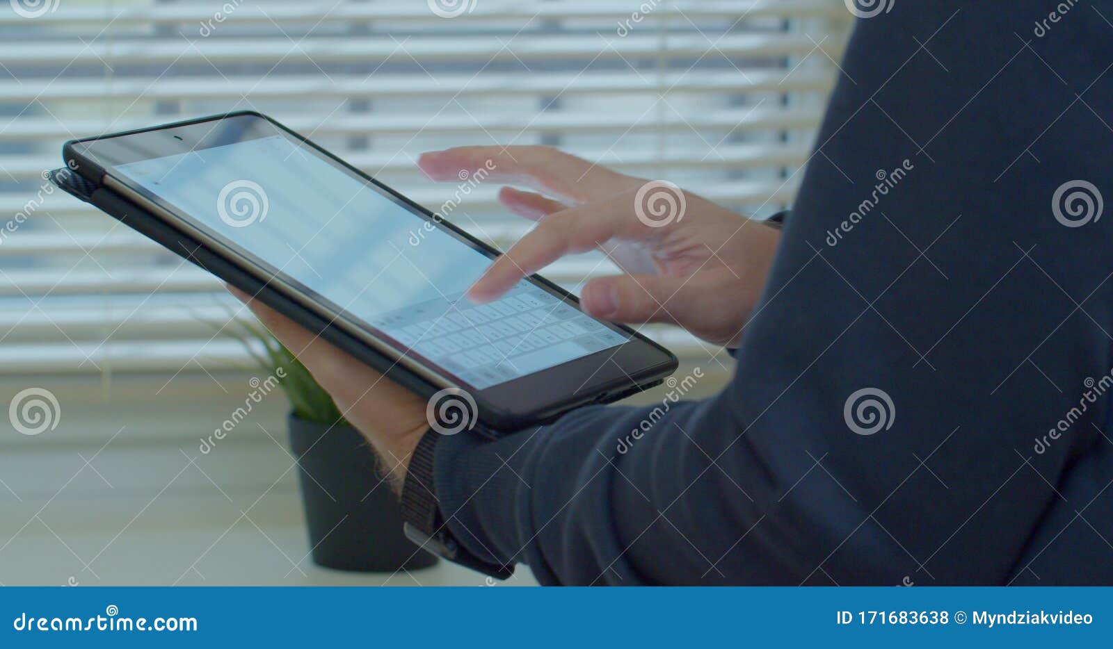 close-up shot of male hands in profile typing in messenger using tabletpc. hands typing text on tabletpc close-up.