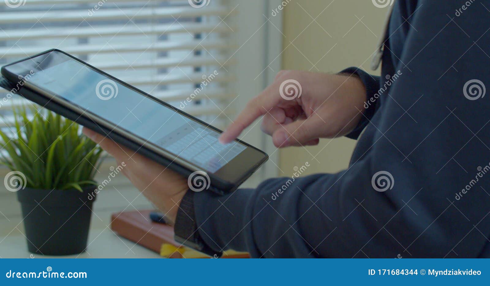 close-up shot of male hands in profile typing in messenger using tabletpc. hands typing text on tabletpc close-up.